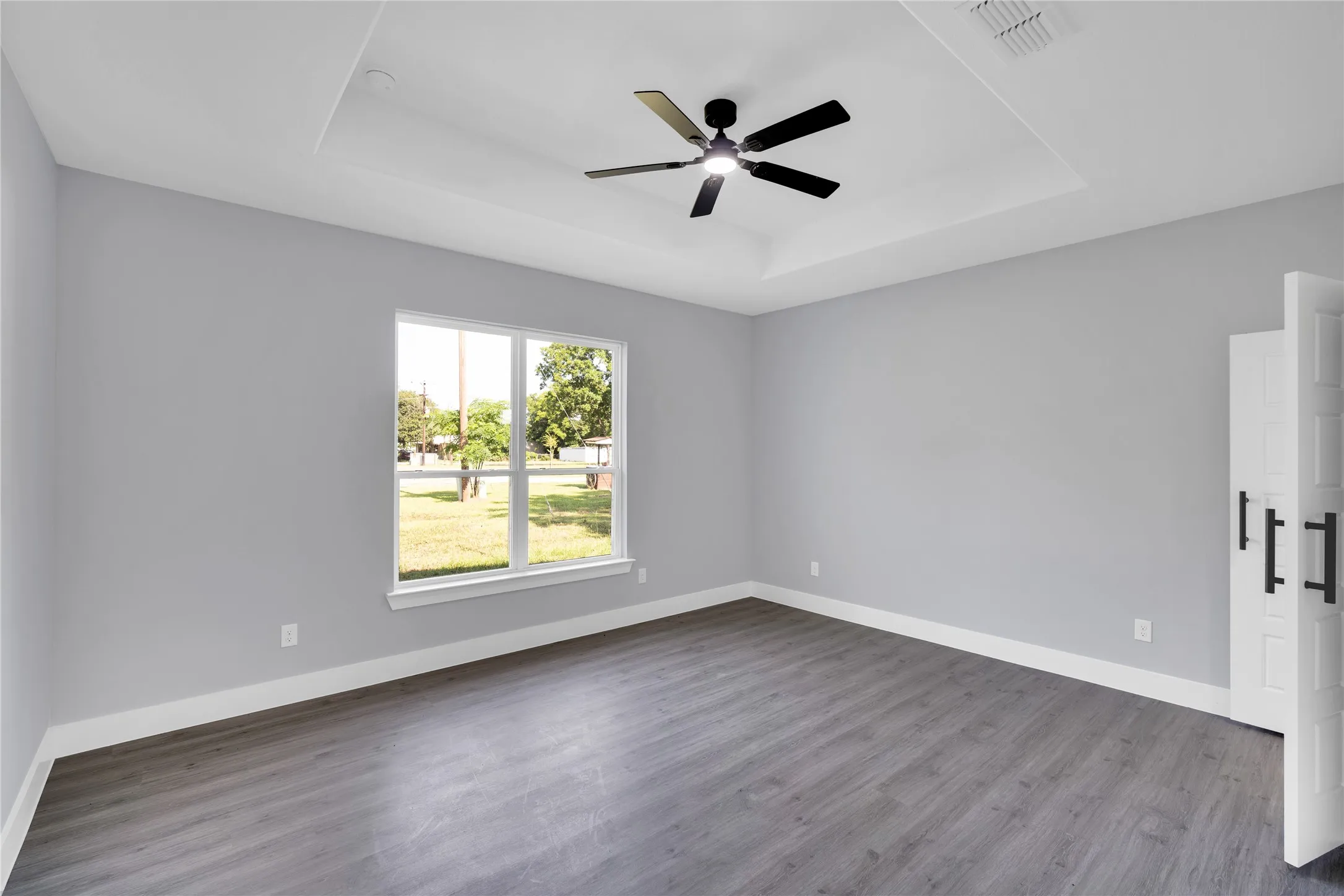 Tray ceiling featuring a contemporary ceiling fan