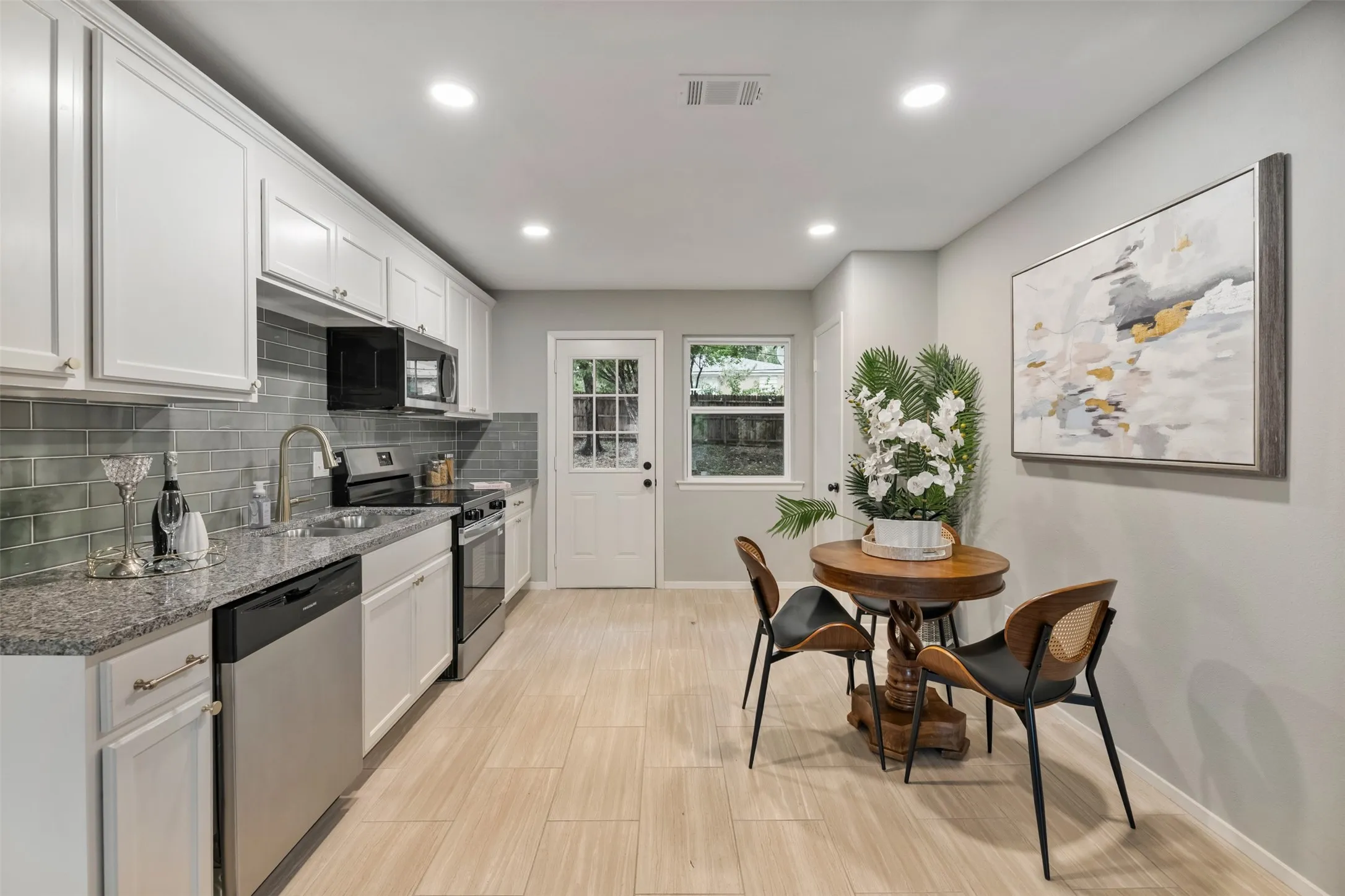The kitchen has new cabinets, granite counters, stainless appliances and back splash.