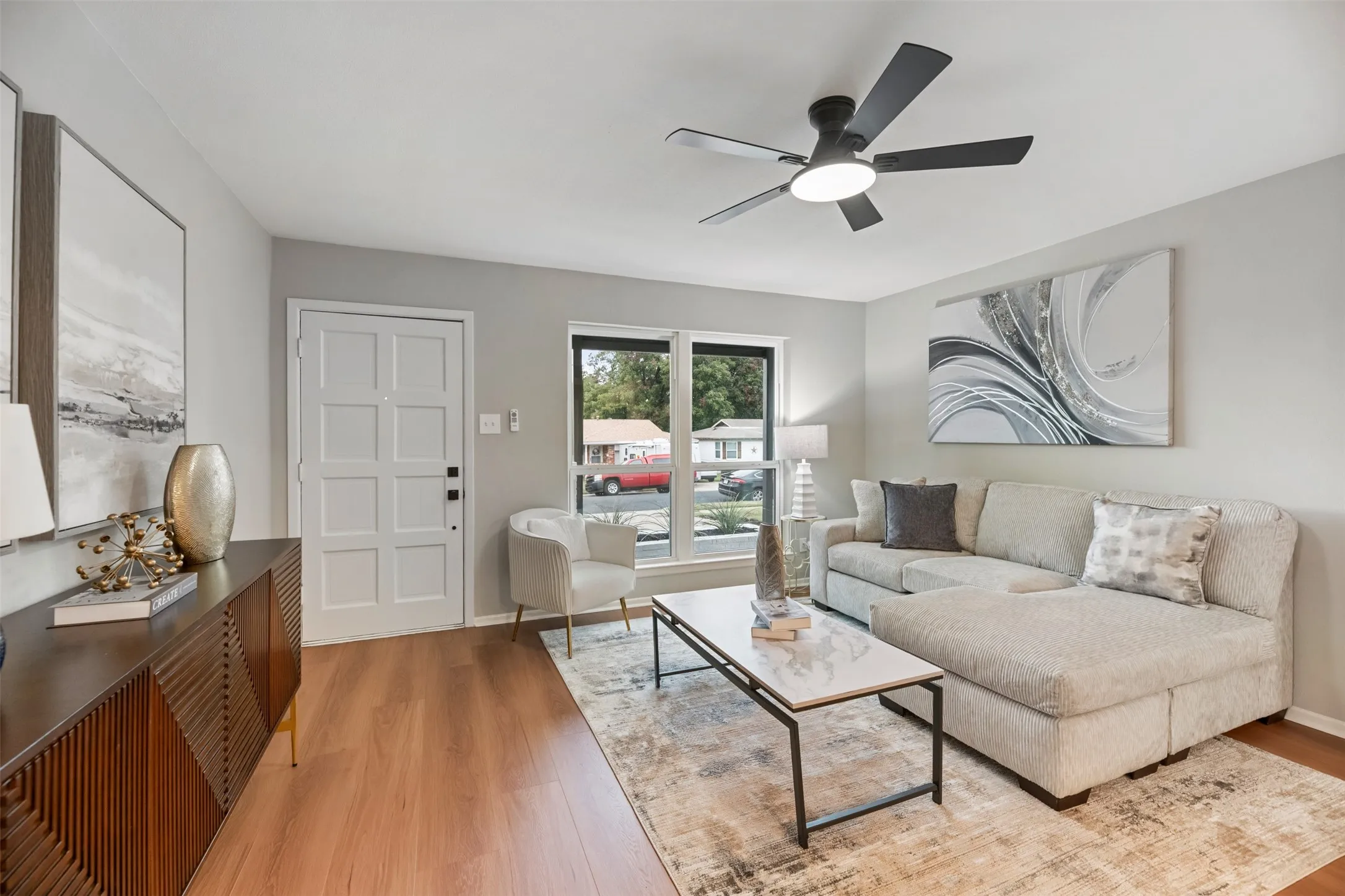 Living room with new floors and a new ceiling fan