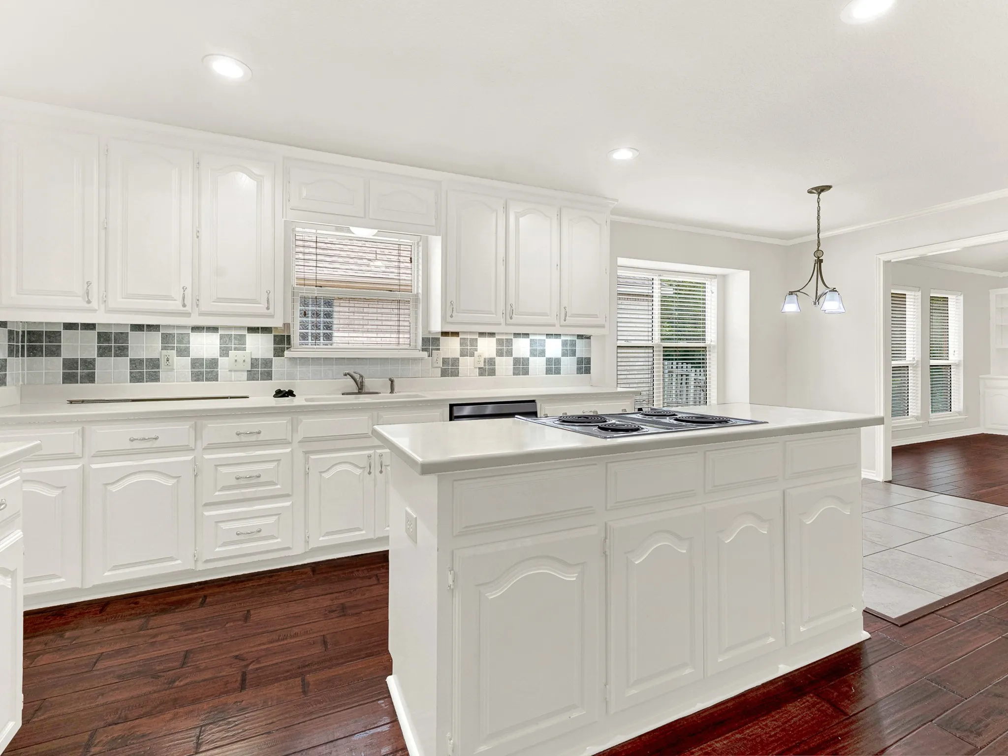 Modern, light color palette in the kitchen with a pop of color in the backsplash