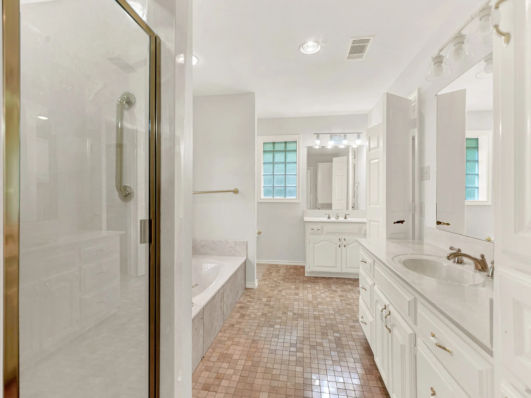 Primary bathroom features separate bathtub and shower, and His and Her sinks