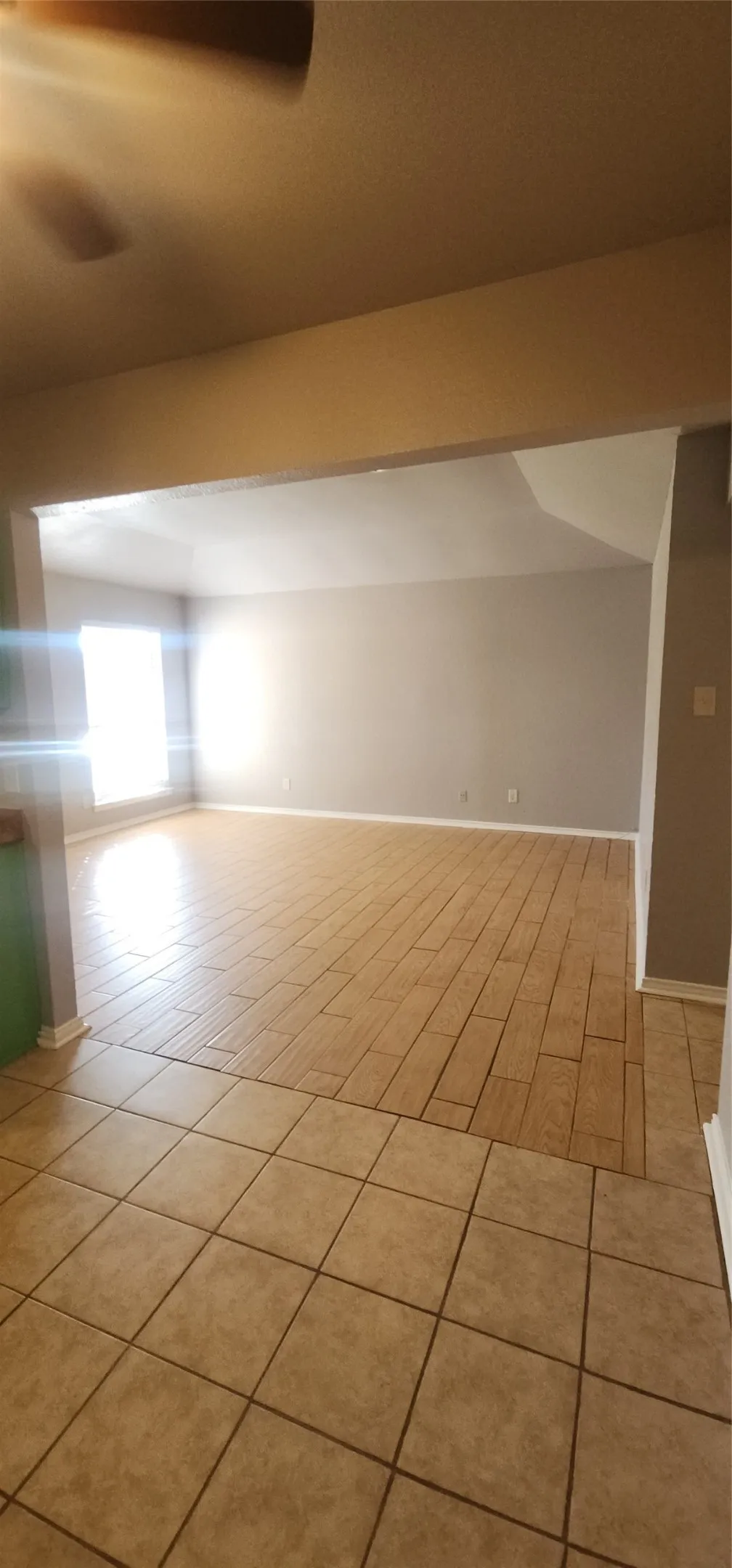 Spacious interior with neutral wall tones and tile flooring throughout