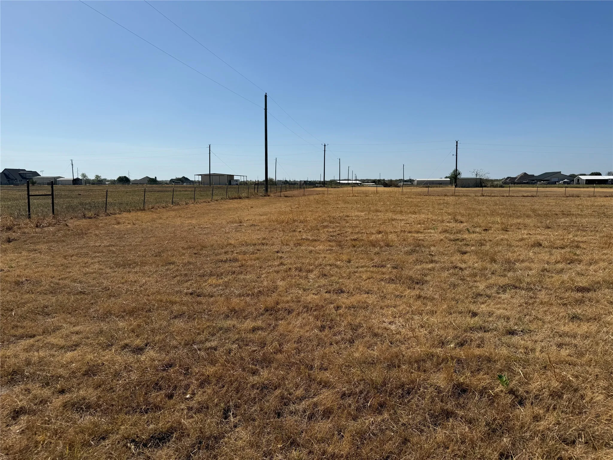 Expansive undeveloped land with a partial wire fence