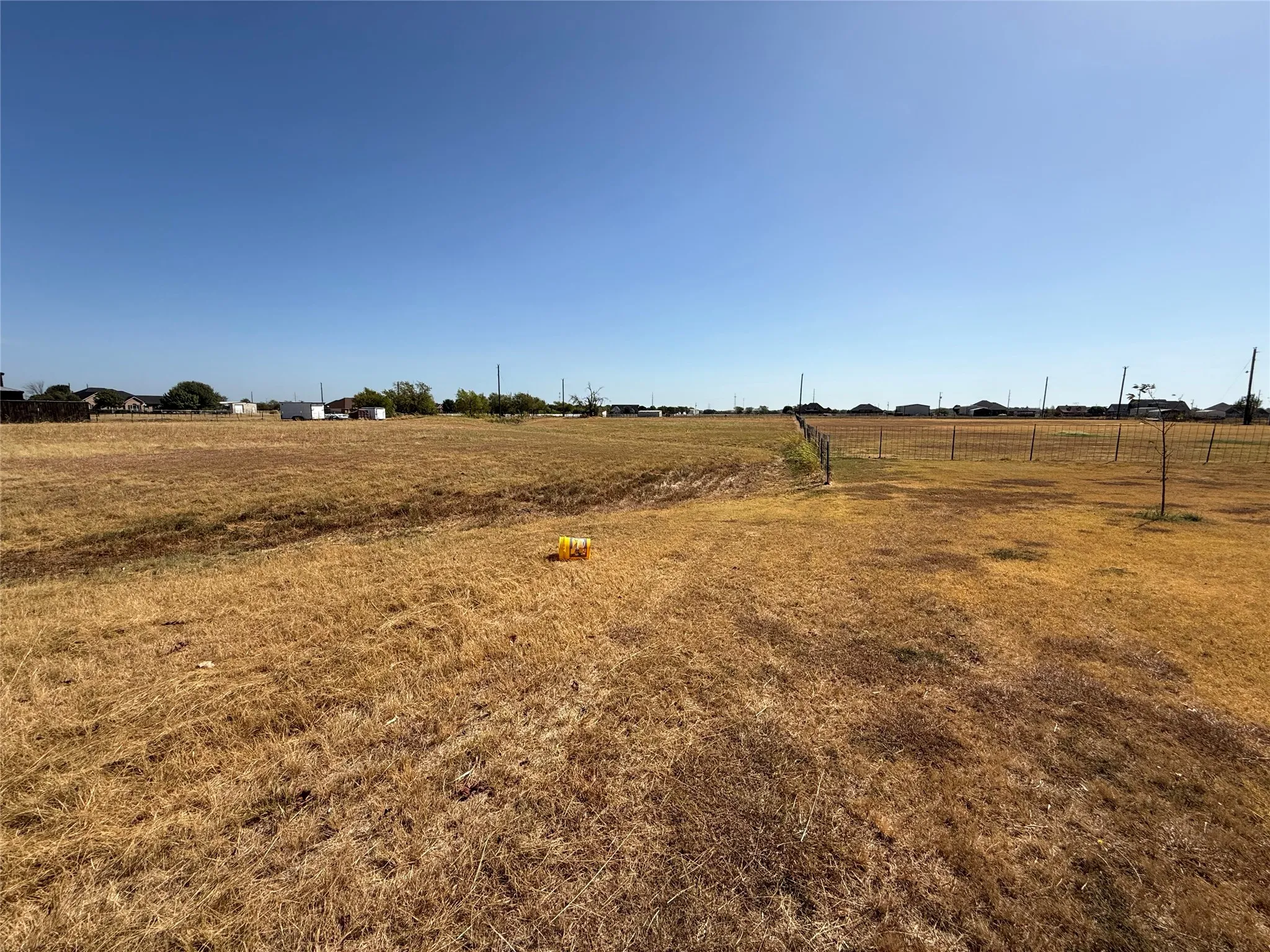 Expansive open land with a wire fence boundary