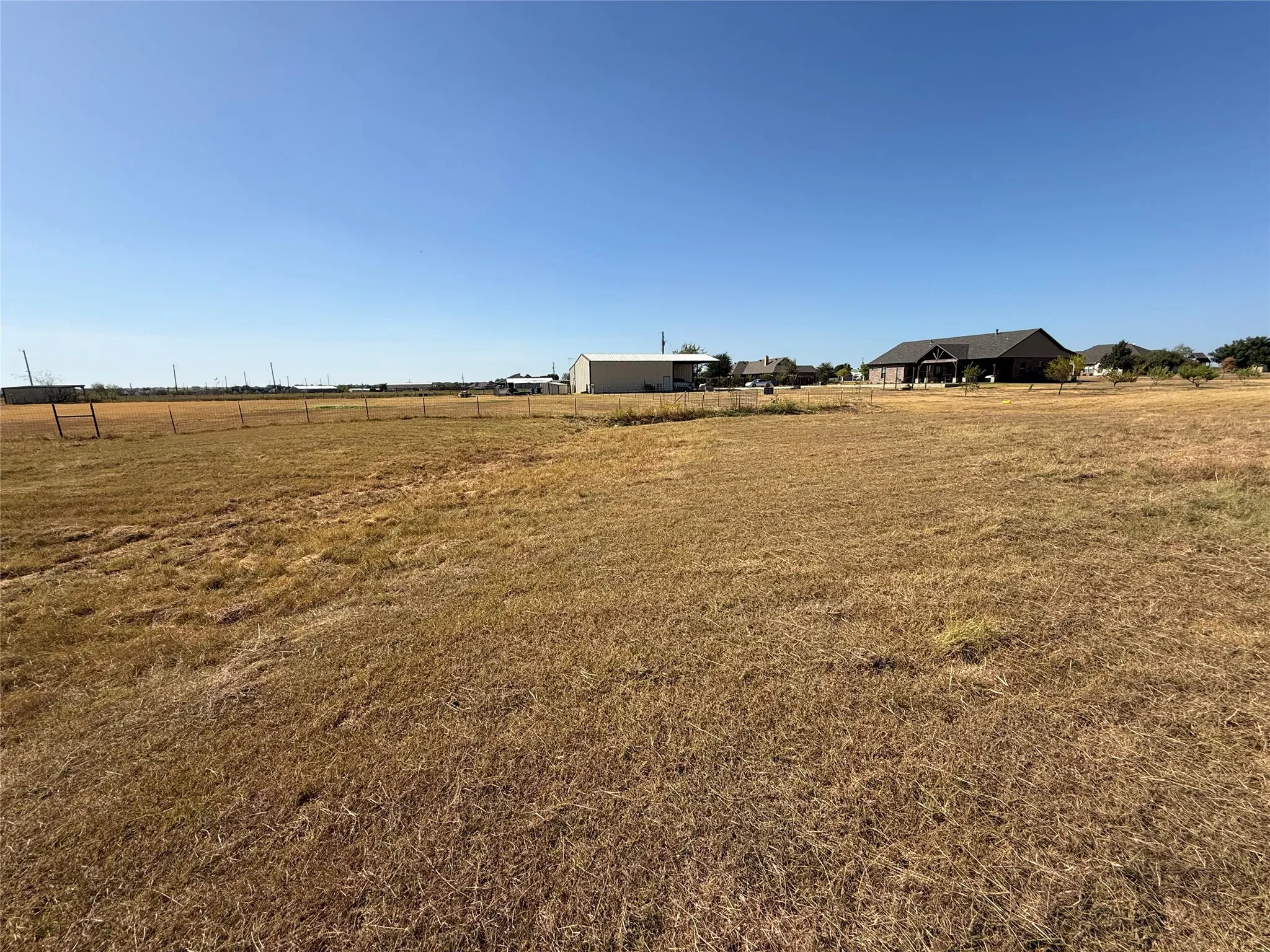 Expansive open lot with a clear sky backdrop