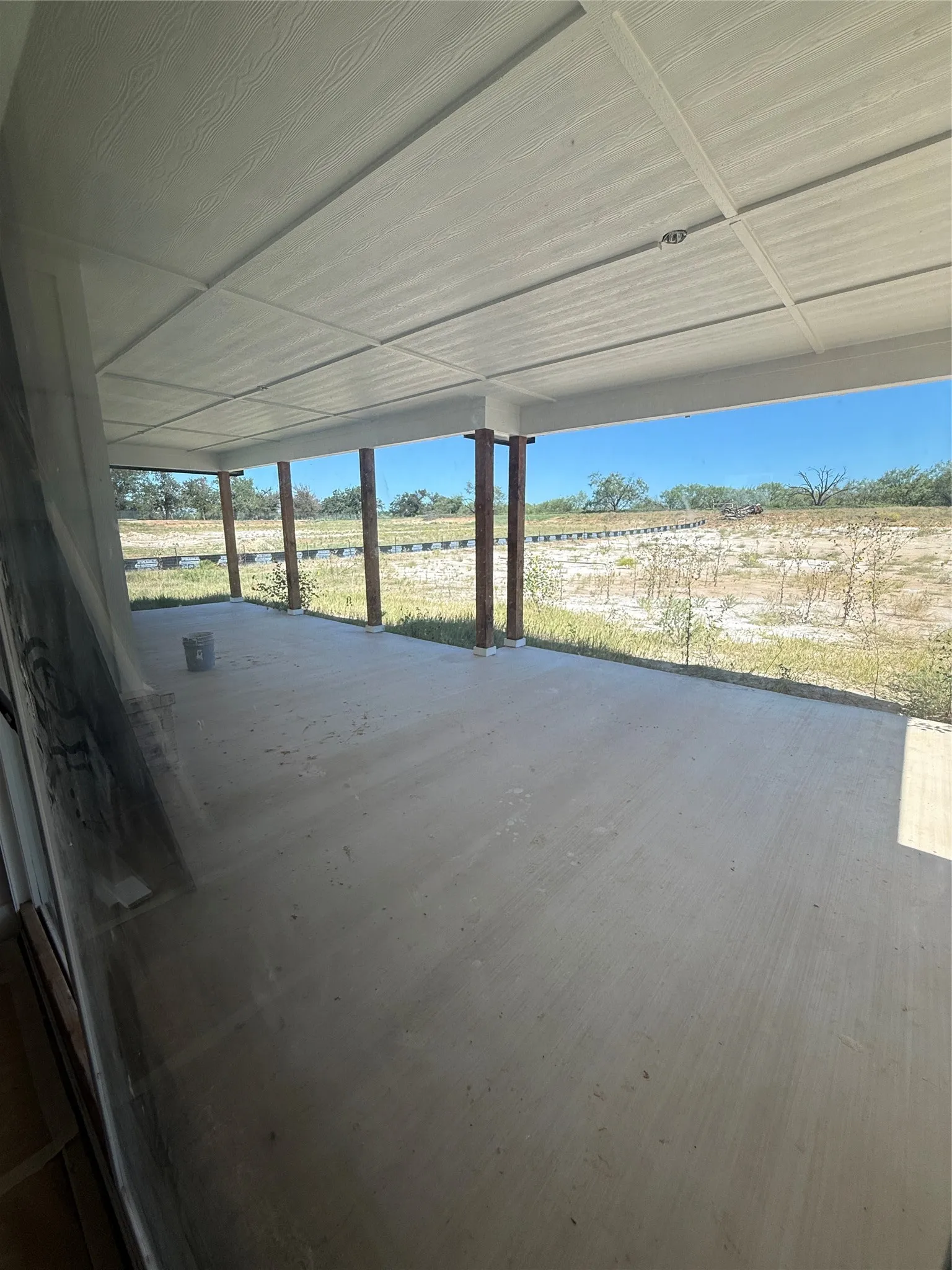 Looking out of double glass sliders to back porch