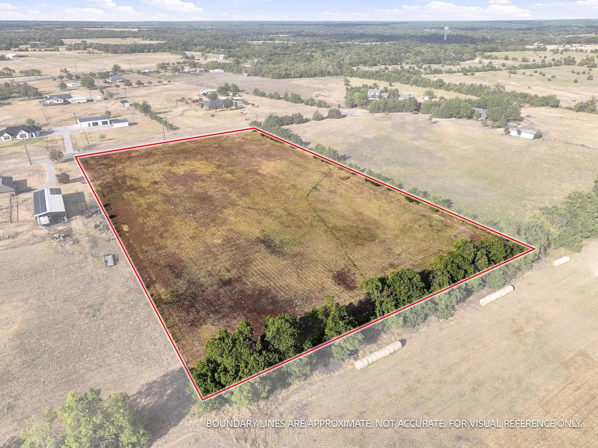 Expansive land parcel featuring clear ground and established tree lines