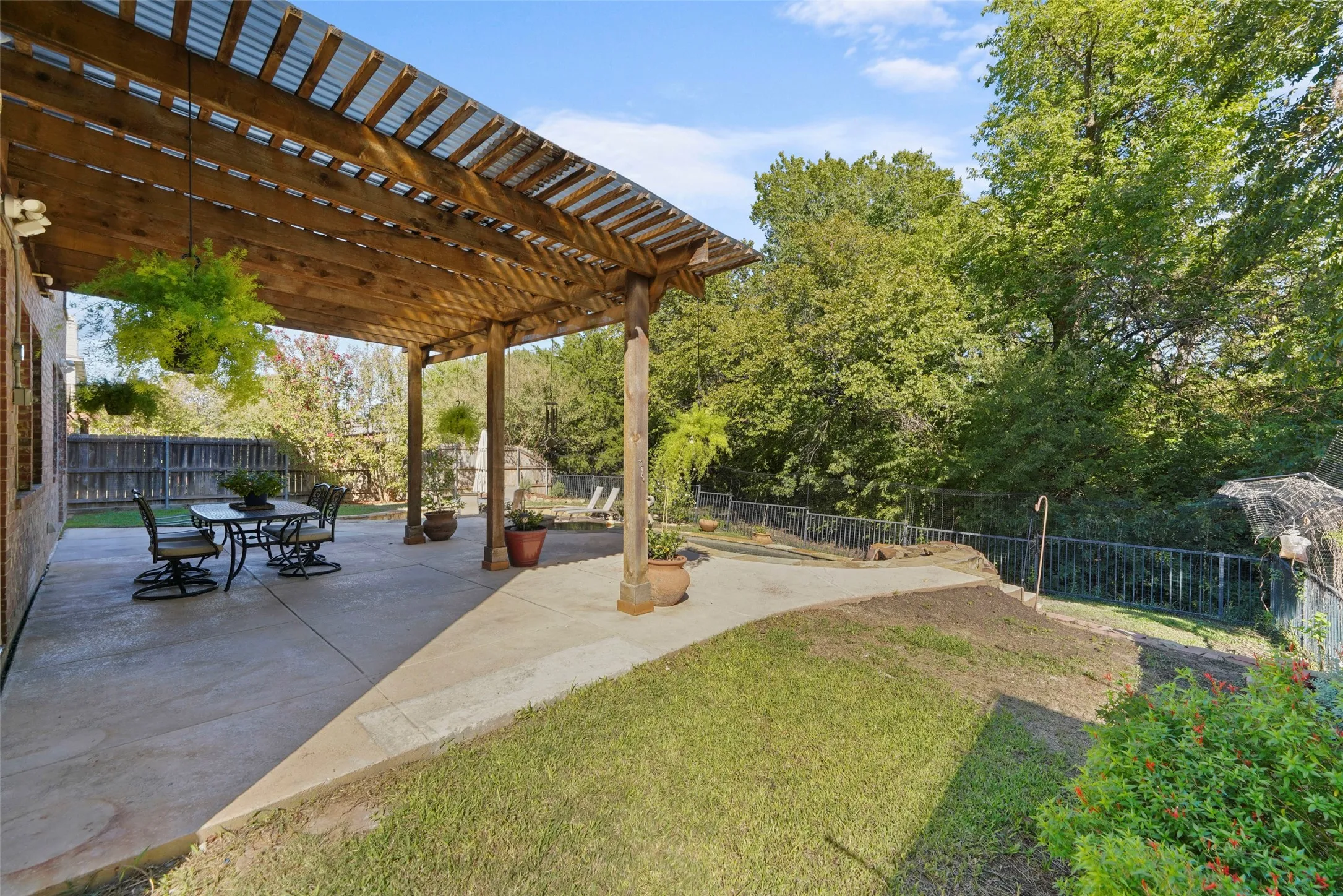 Covered patio with a wood pergola structure and translucent roof panels