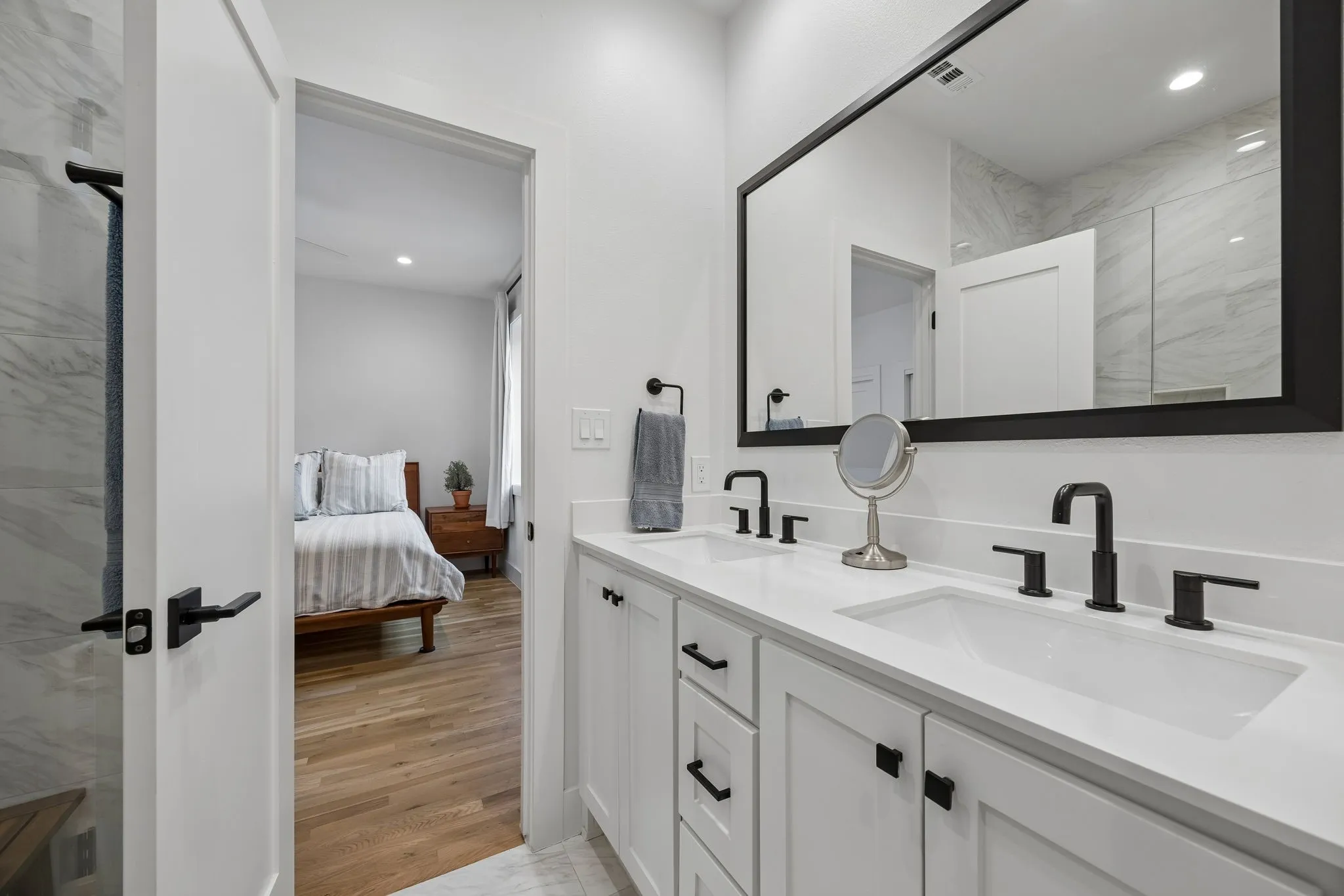 Bathroom with recessed lighting, double vanity, a marble finish shower, ensuite bath, and light wood-style flooring
