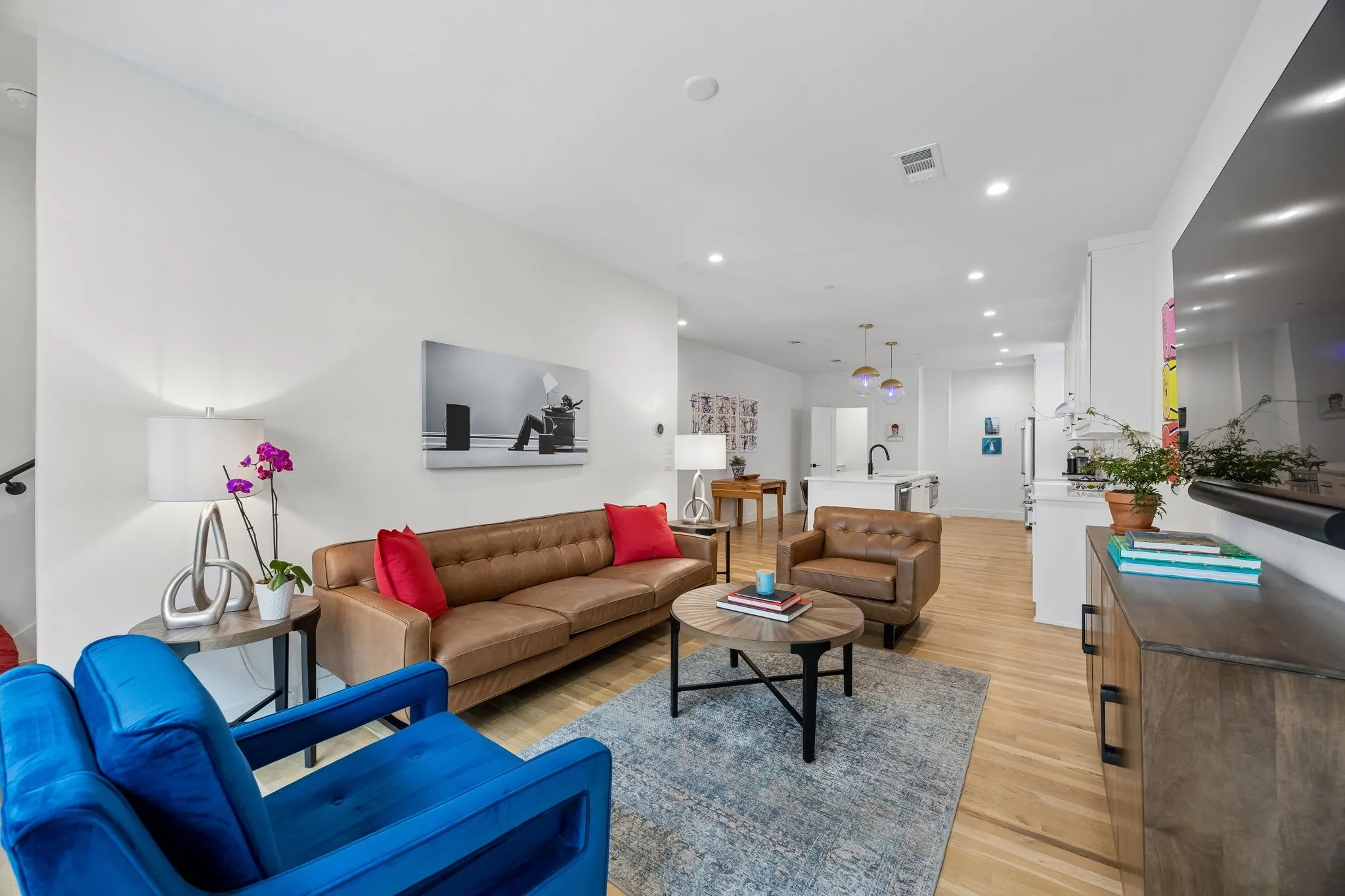 Bright and inviting living area featuring light oak wood flooring, recessed lighting, and an open floor plan filled with abundant natural light, creating an airy and welcoming atmosphere ideal for everyday living and entertaining.