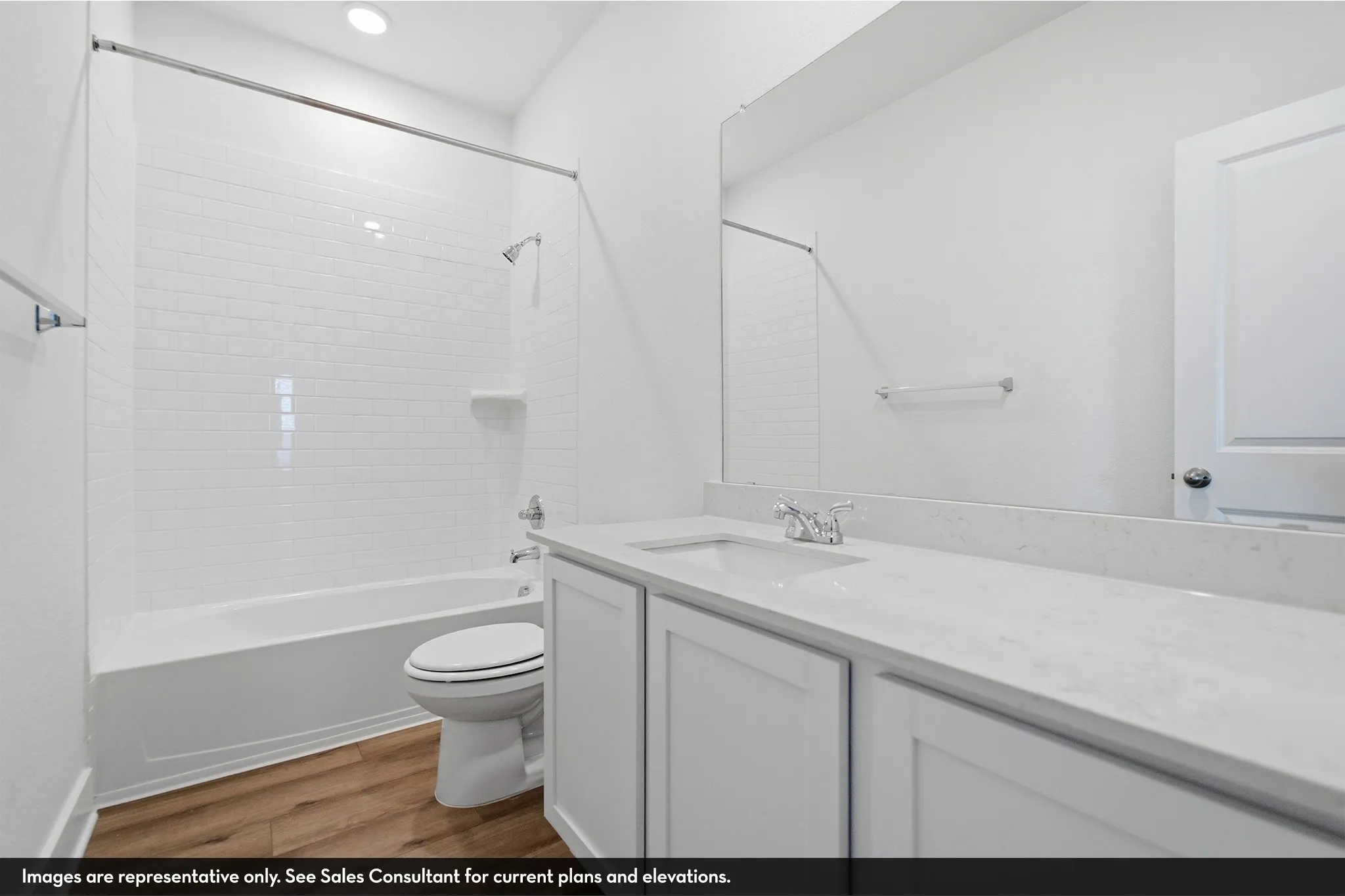 White subway tile shower surround with a built-in tub, single vanity with integrated sink, and white wood-finish cabinetry