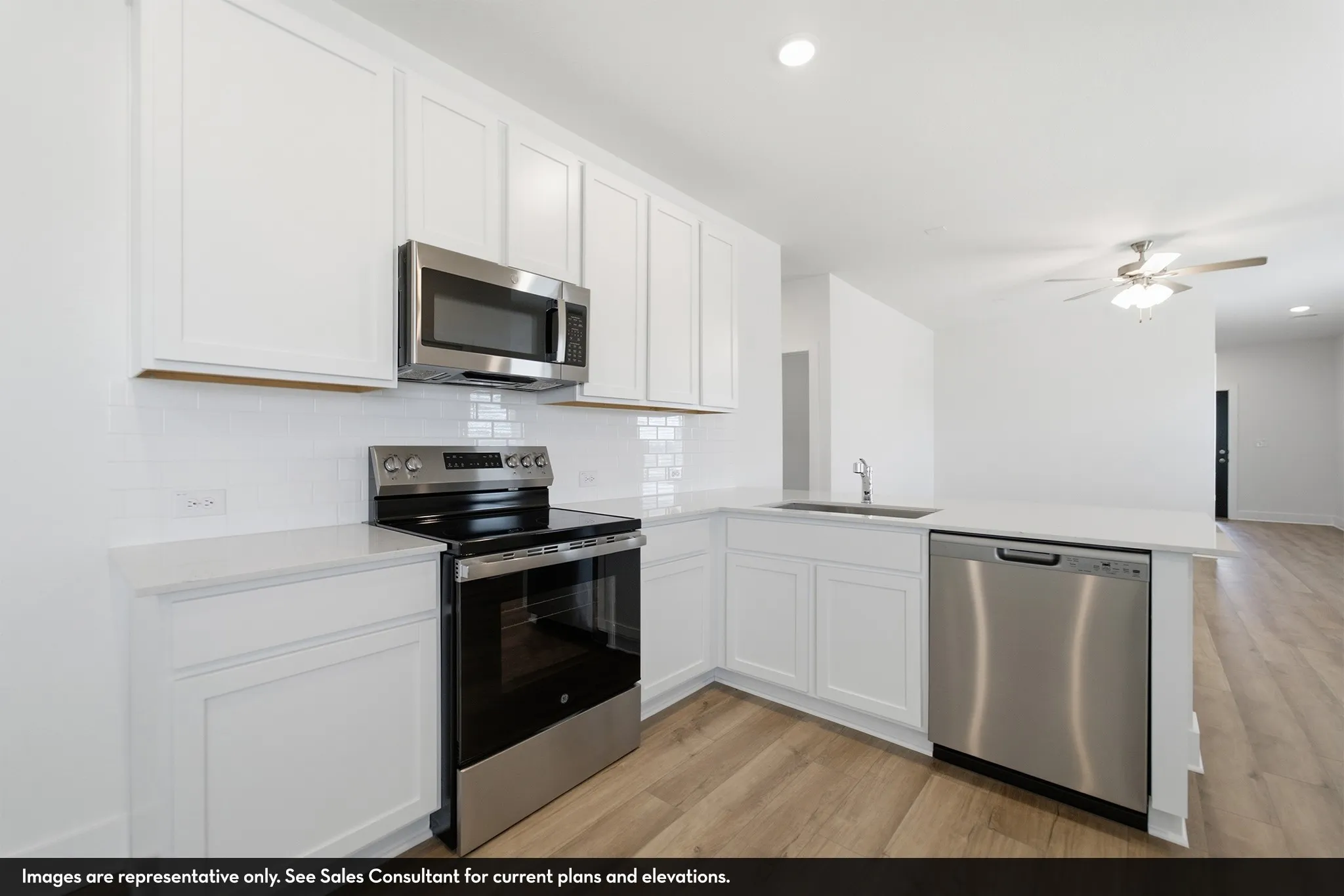 Kitchen with white shaker cabinetry, stainless steel appliances, white subway tile backsplash, and wood-finish flooring