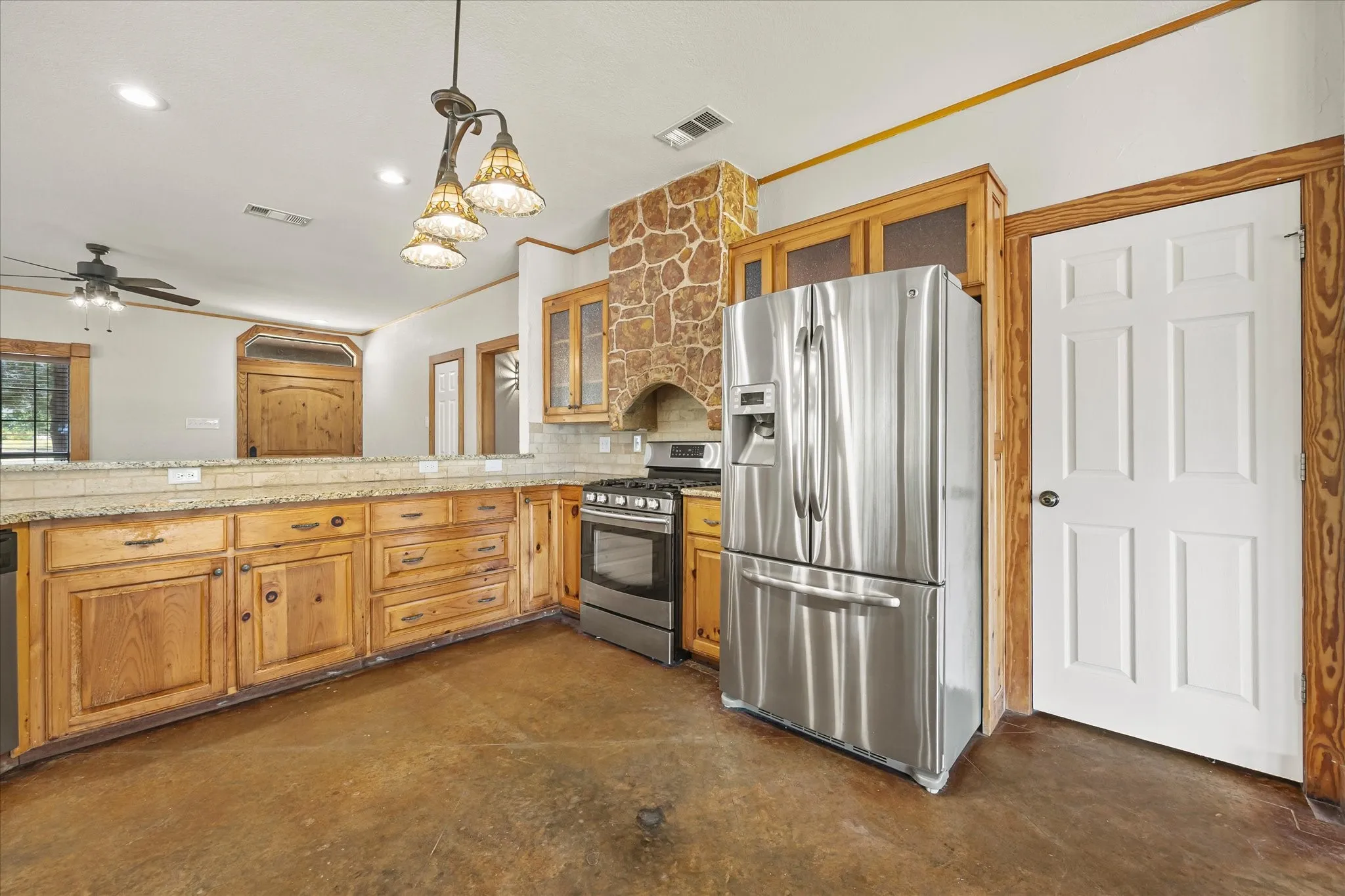 Stainless steel refrigerator stays. Easy-care stained concrete floors.