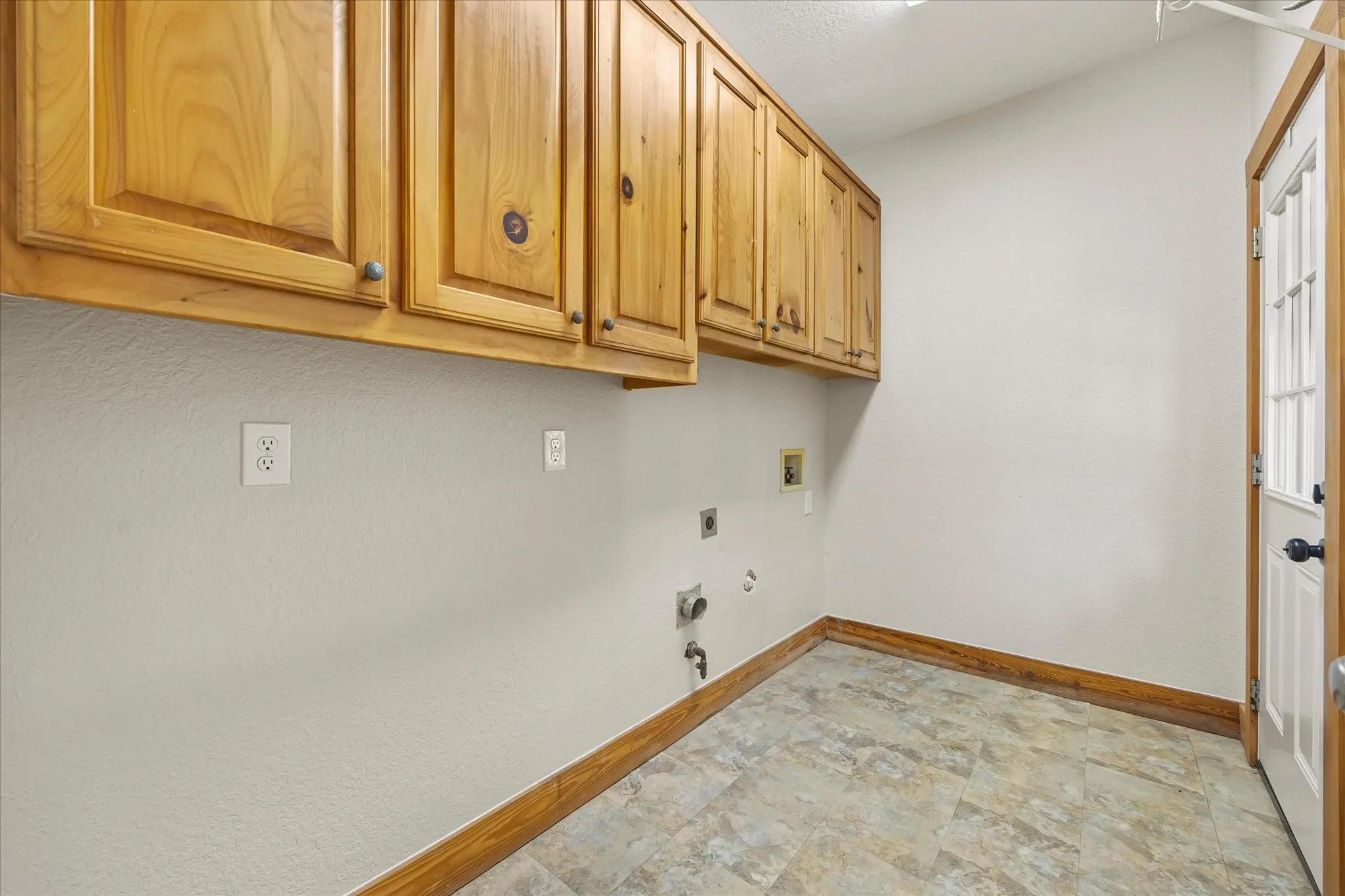 Laundry room with storage at your back door with room for full sized appliances and deep freezer.