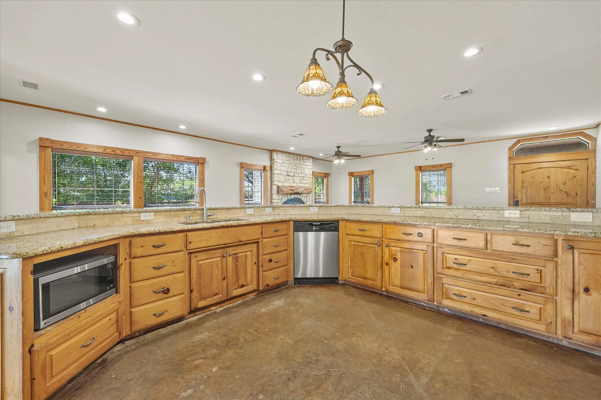 Natural wood cabinetry, granite counters, stainless steel appliances, propane-powered gas range. Room for portable center island.