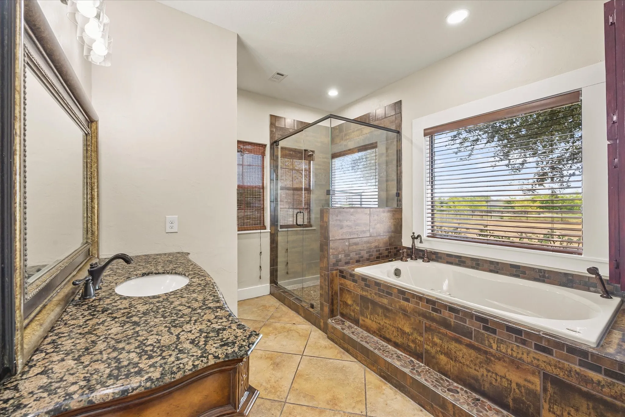 River-rock accents elevate the shower and tub.