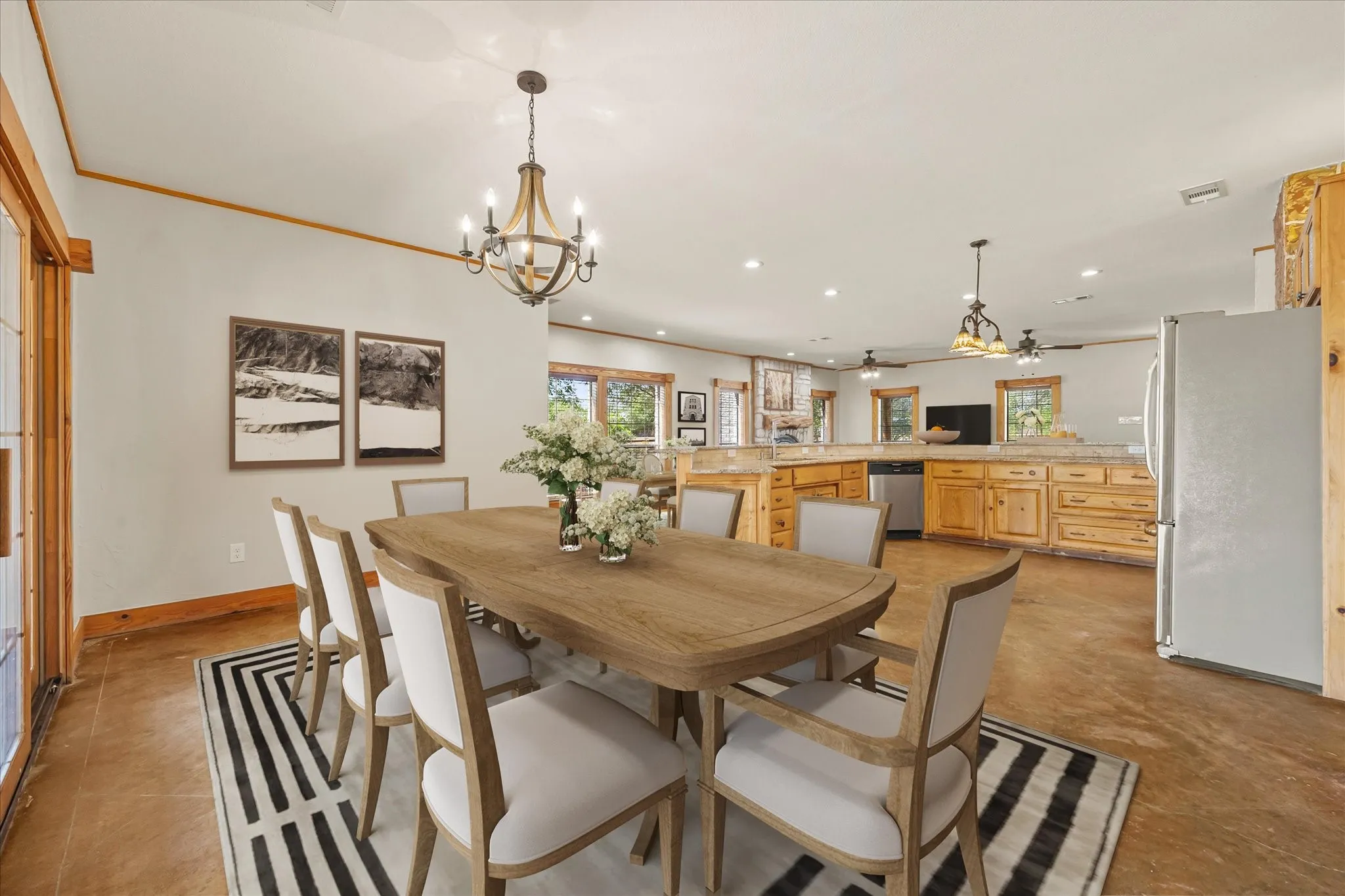 Virtually staged. Large dining area overlooks bank of sliding doors onto the flagstone patio with idyllic pasture views beyond.