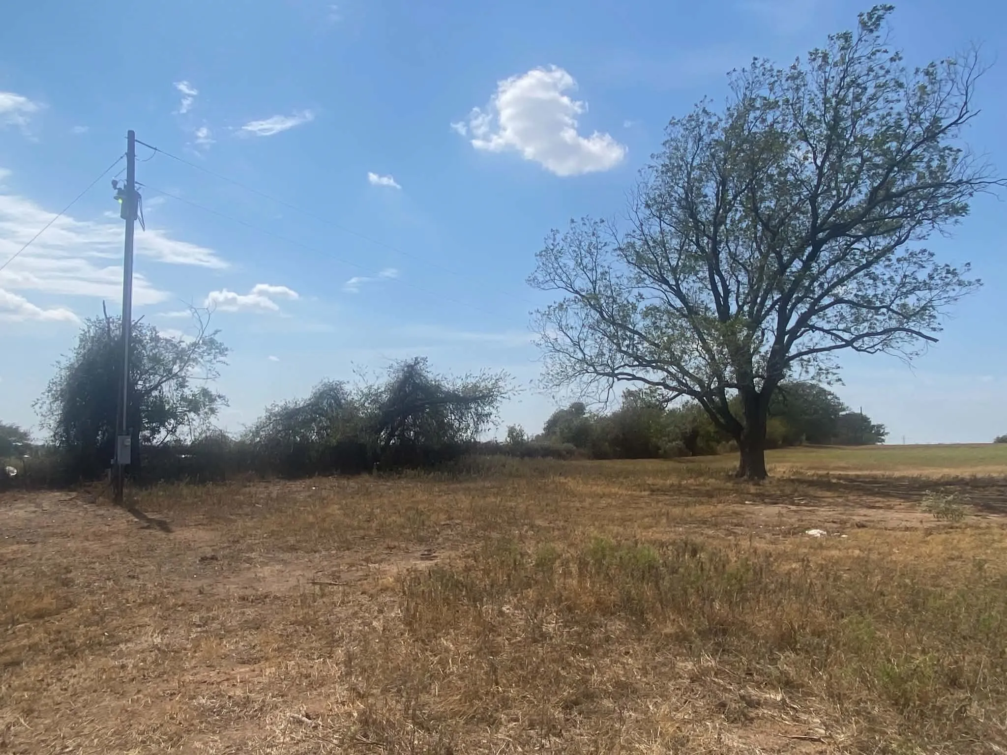 Utility line access located near rear property line. Septic tank also located in this general area. Buyer to verify location, condition, availability, and functionality of all utilities and septic.