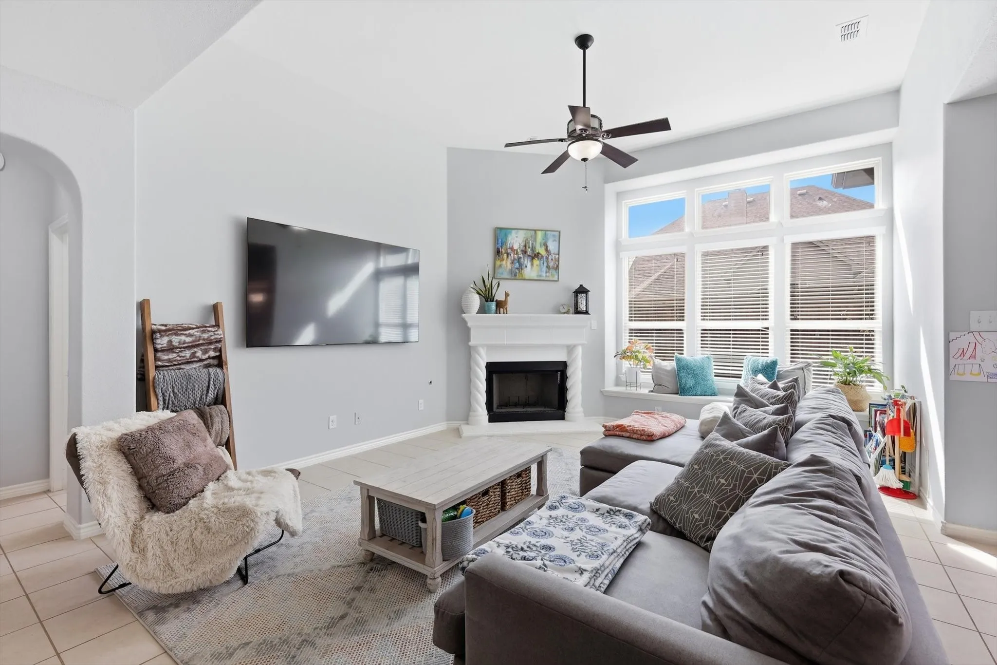 A cozy fireplace and 3 large windows make this the place to be at the end of the day