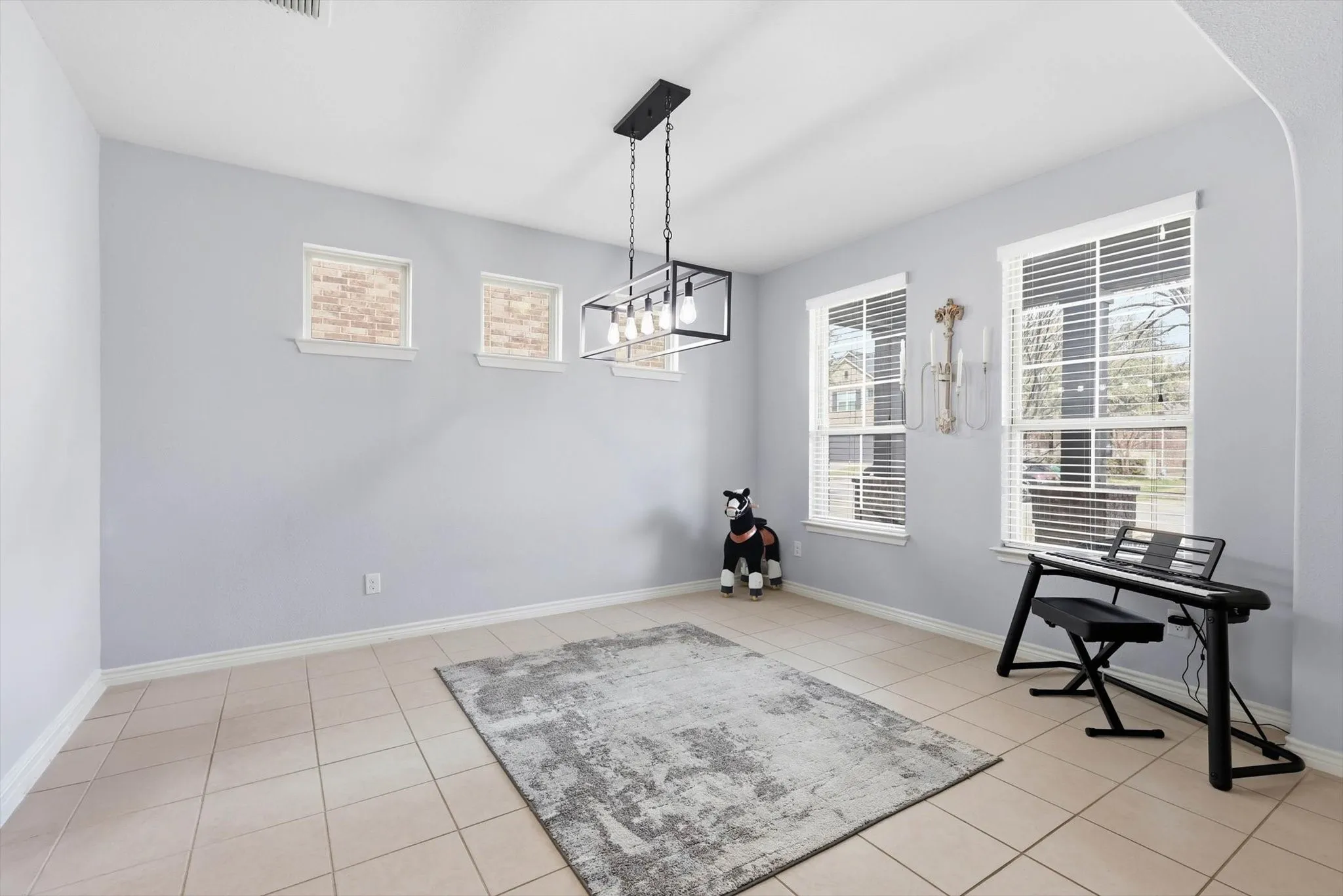A home full of light bright colors and windows. A spacious dining area with decorative lighting