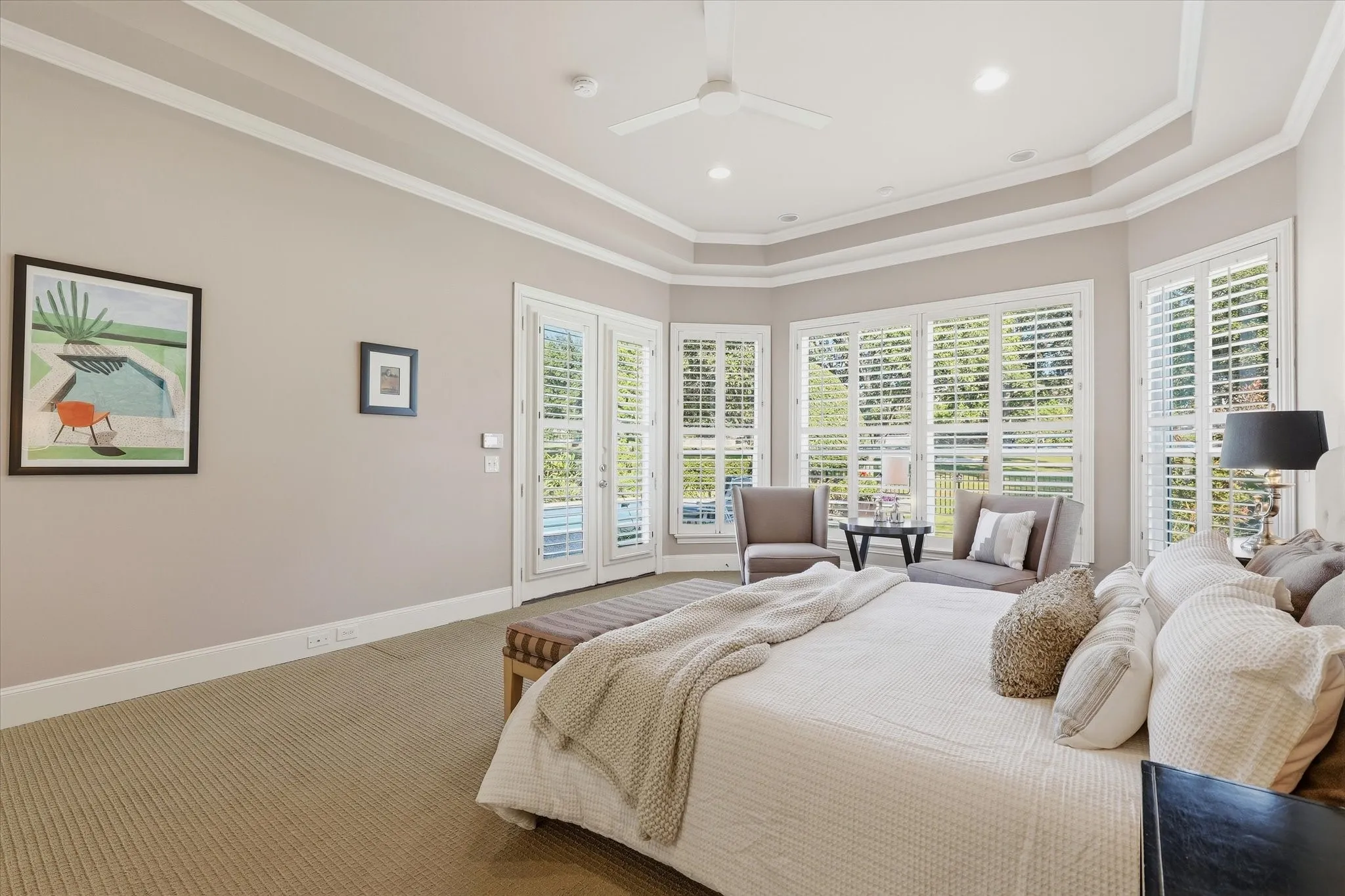 Primary bedroom has double doors to the outdoor living area.