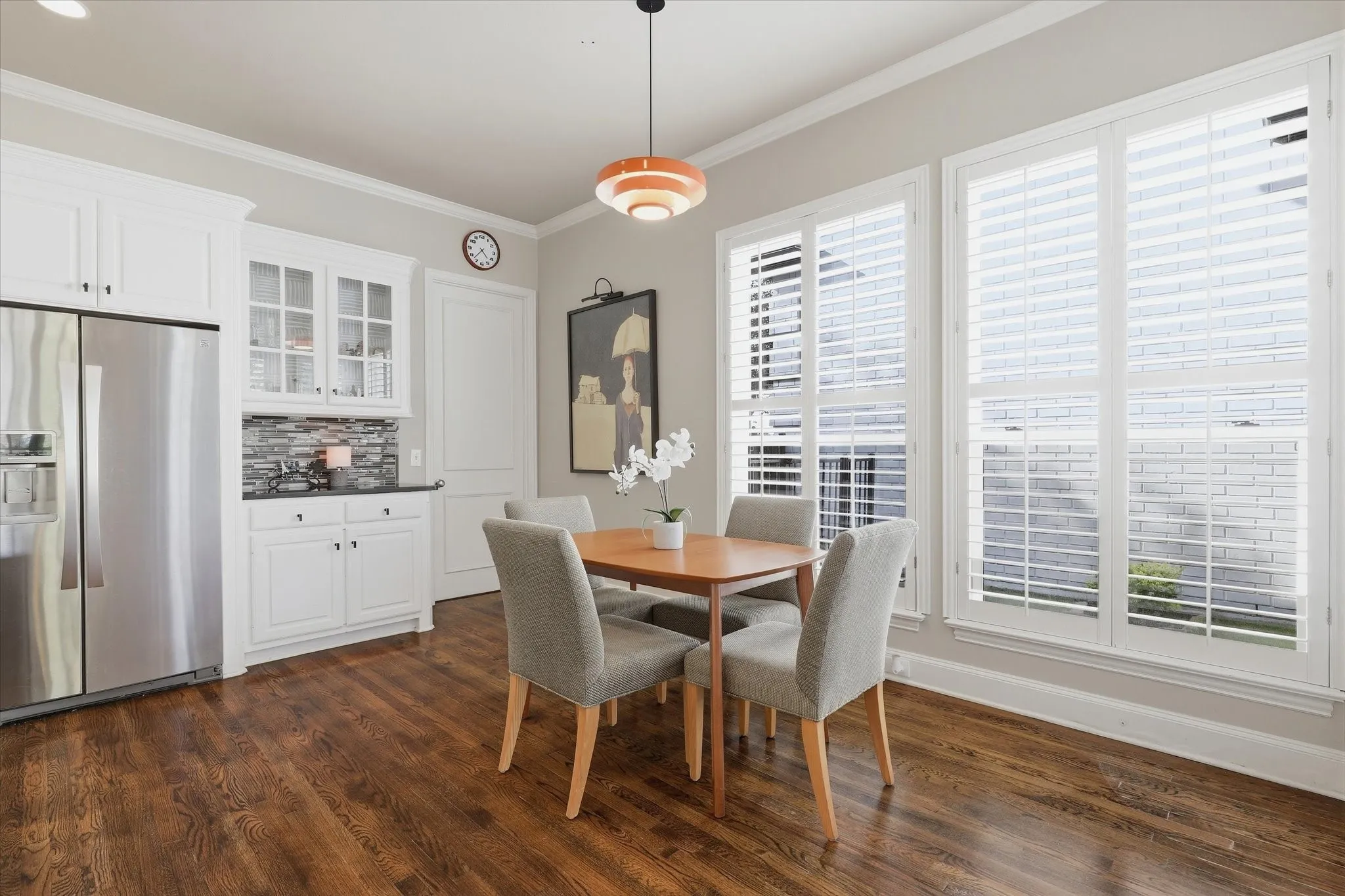 Windows wrap the adjoining breakfast area, drenching it in natural light.