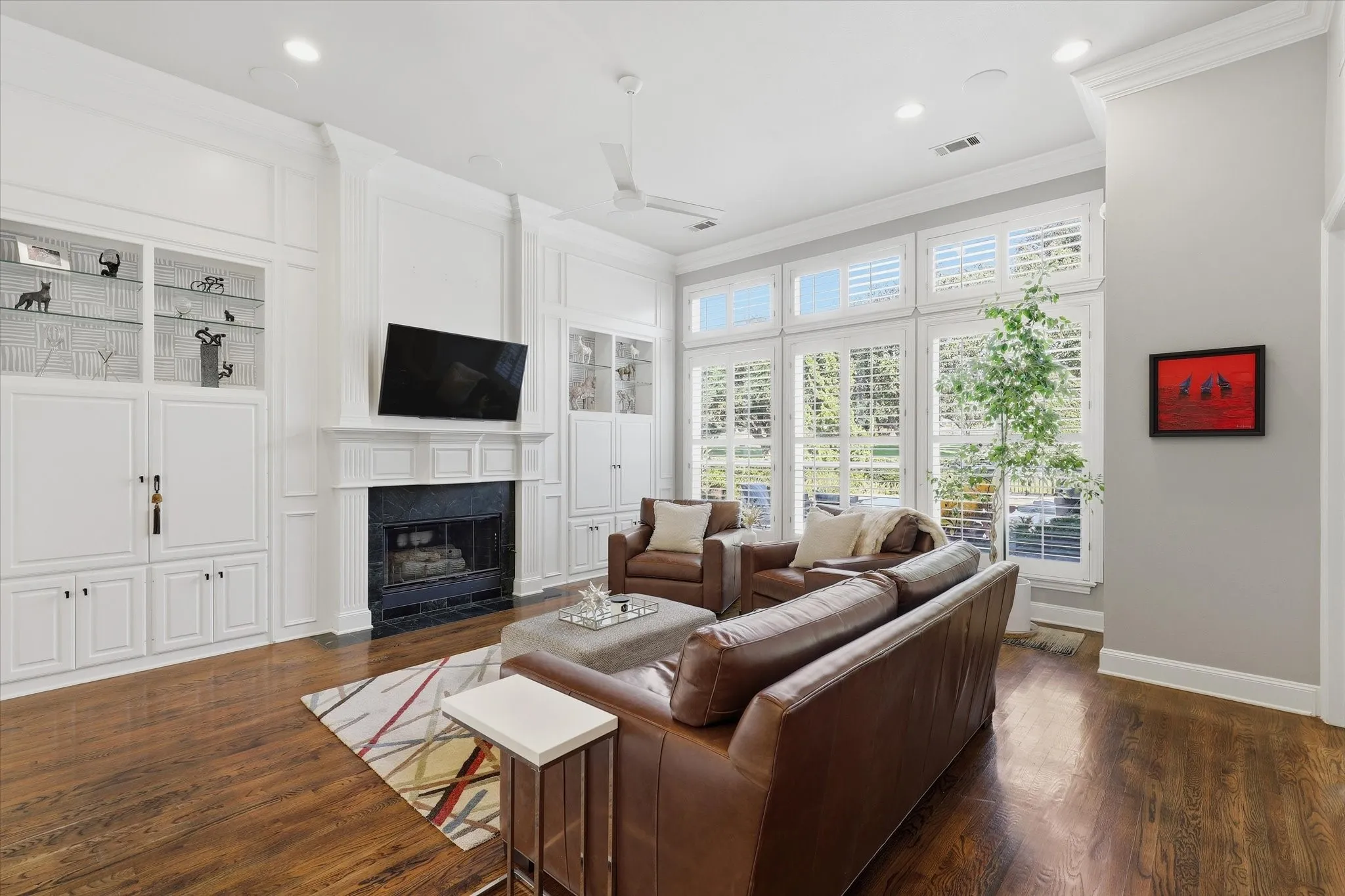 The spacious family room’s wall of windows showcases the backyard oasis and fairway beyond.