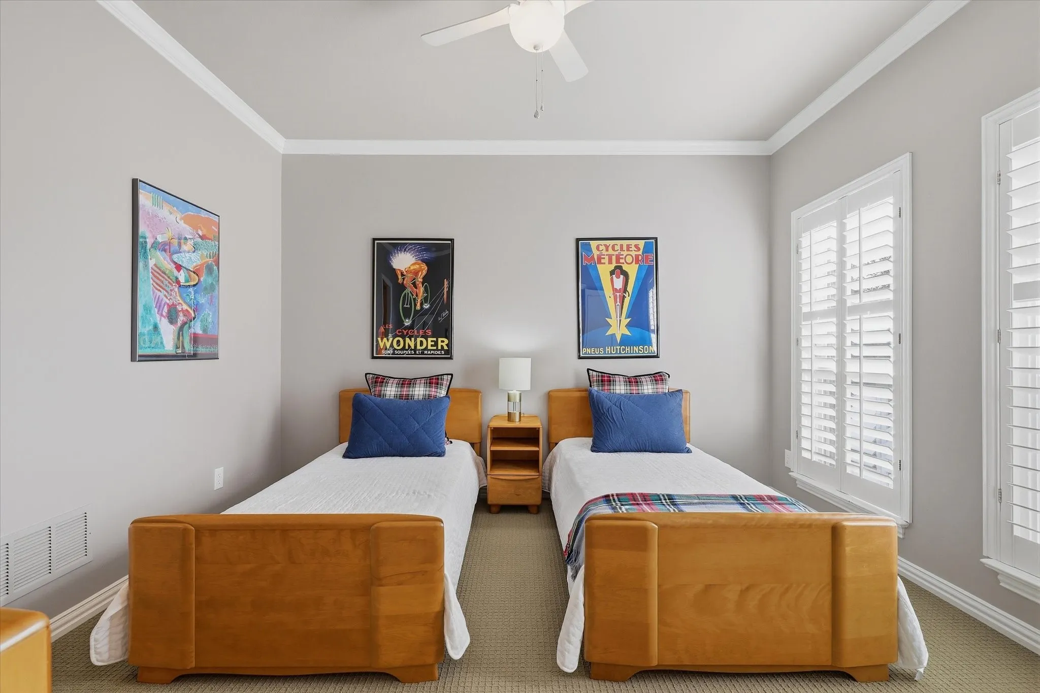 One of two upstairs guest bedrooms, this inviting space features plantation shutters, crown molding and access to the updated Jack-and-Jill bath.