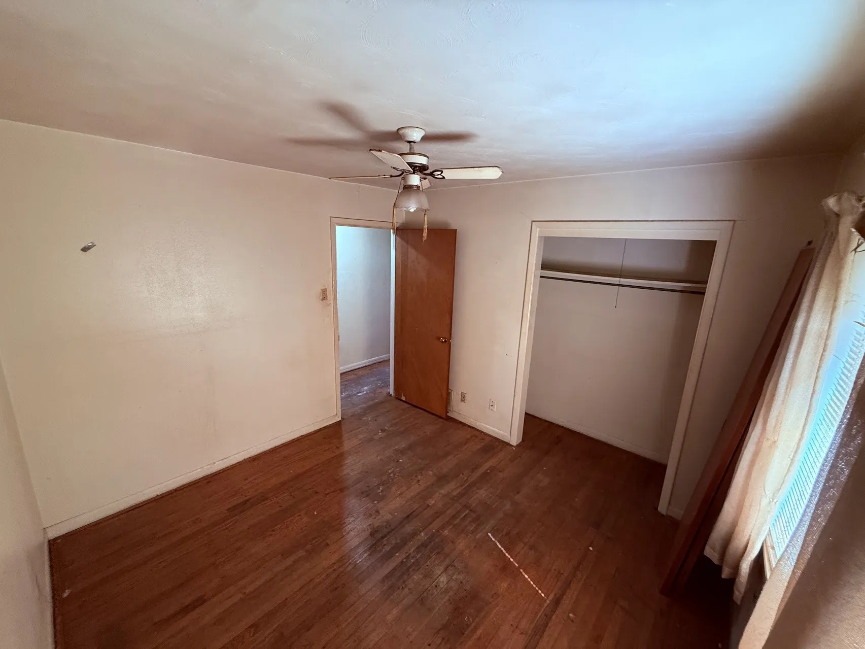 Hardwood flooring, ceiling fan, and dedicated closet space