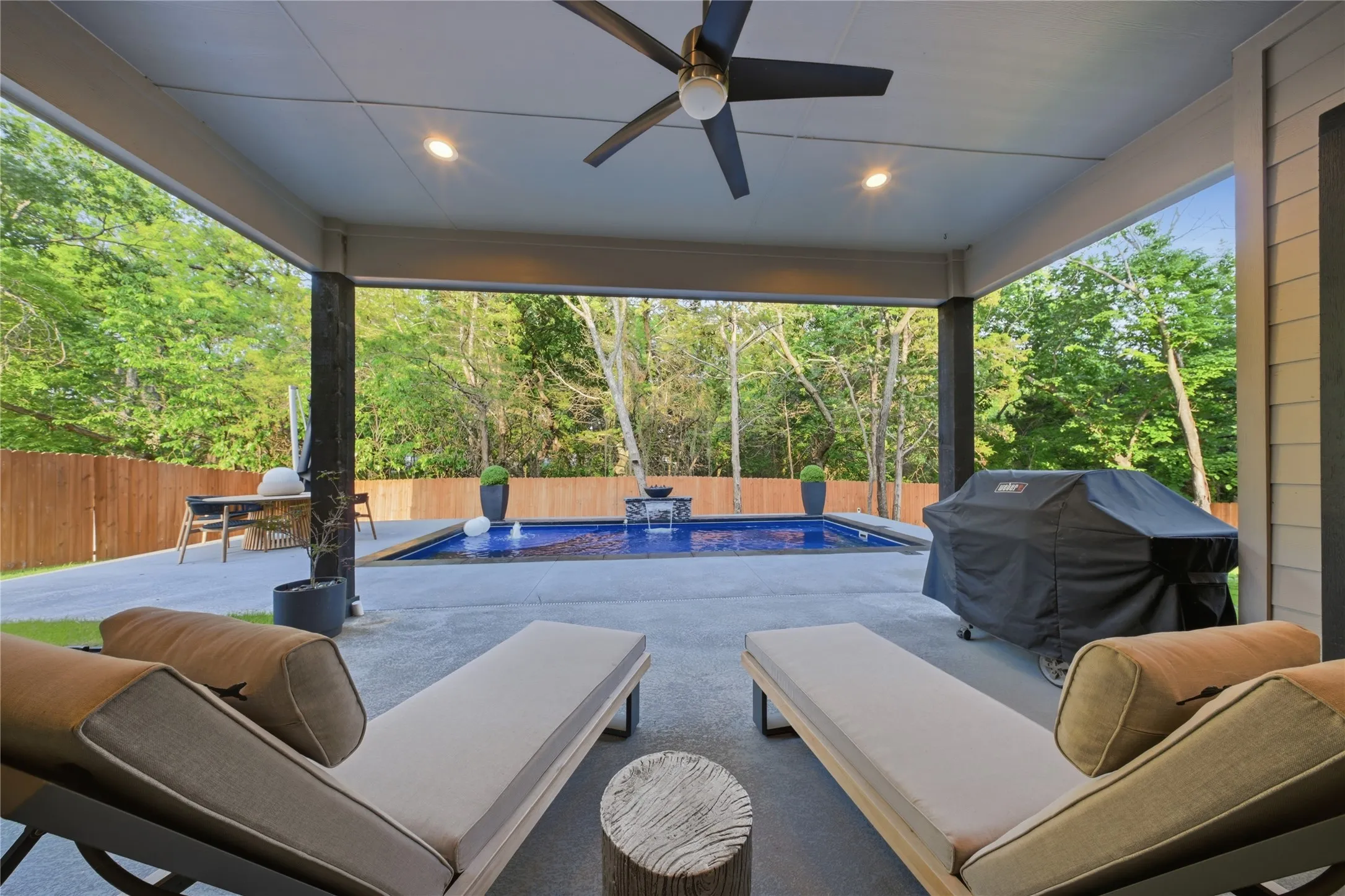 Covered patio with recessed lighting, ceiling fan, concrete flooring, and a swimming pool