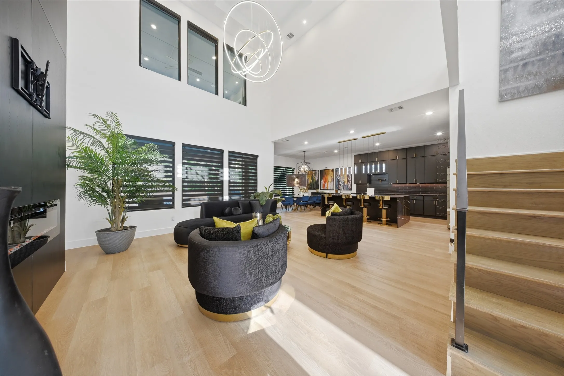 Vaulted ceilings and light wood-finish flooring throughout the open-concept living area