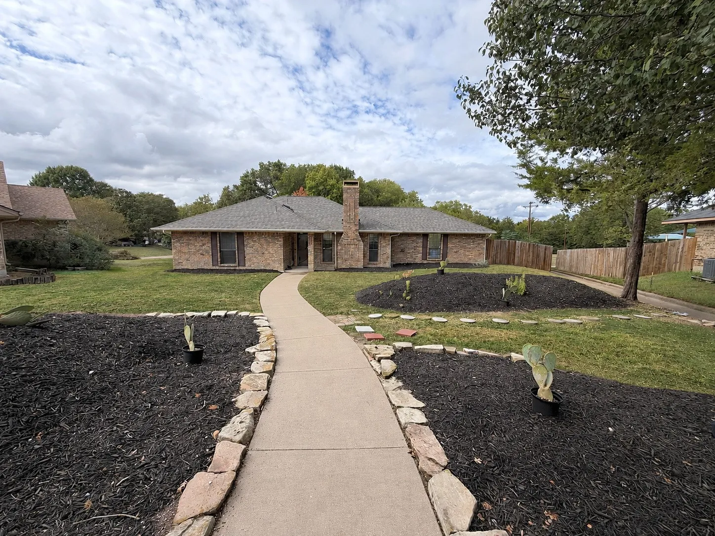 Brick exterior with a shingle roof and a prominent chimney