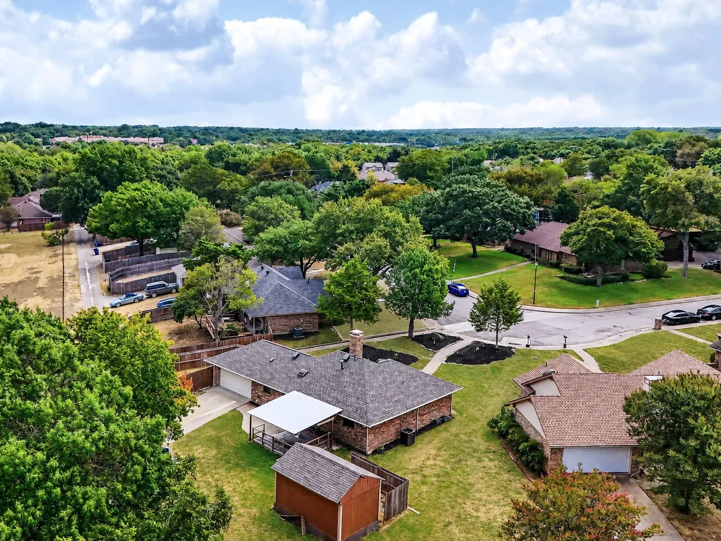 Mature trees and established landscaping surround the property