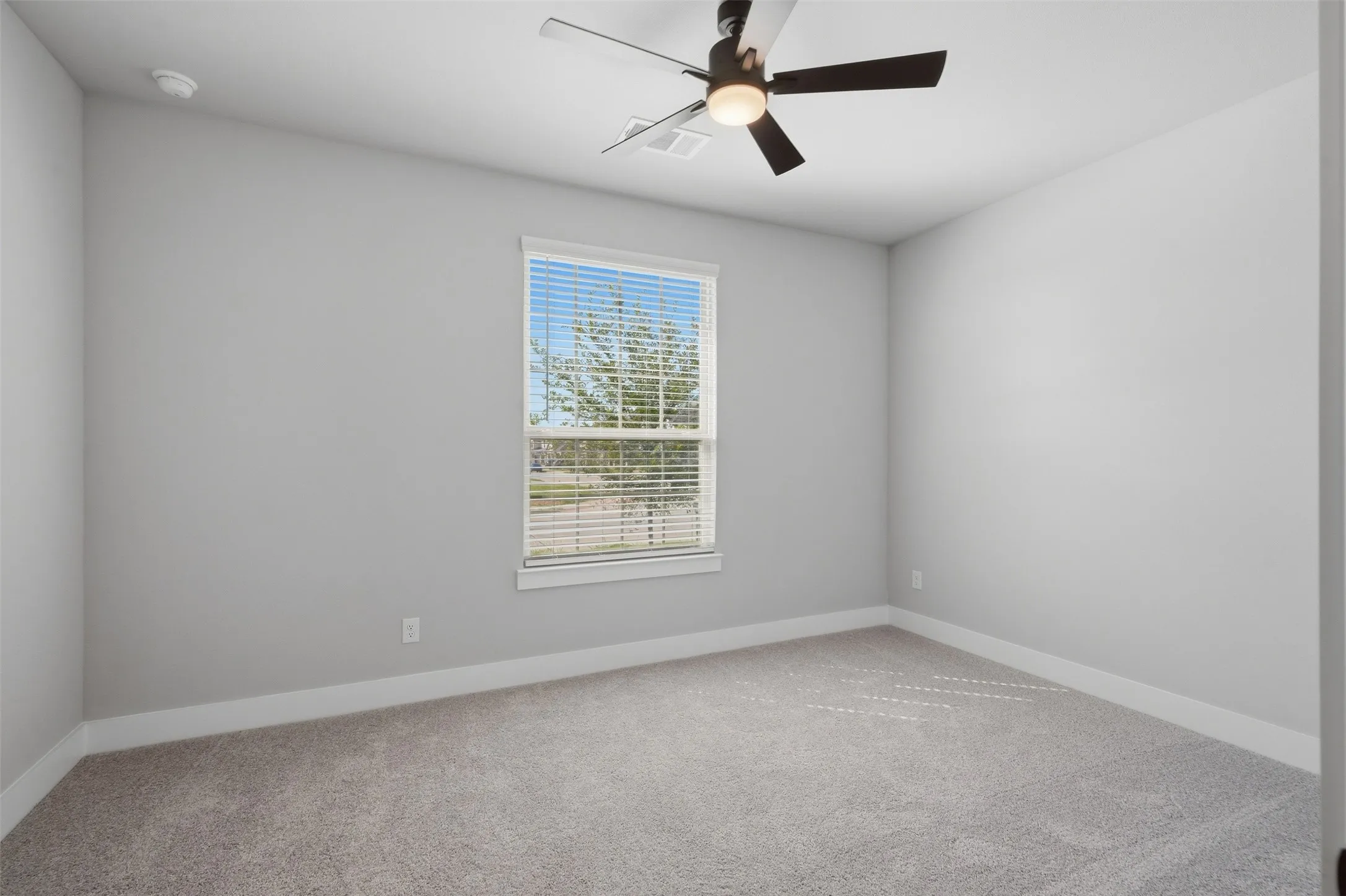 Recessed lighting, ceiling fan with integrated light, neutral carpet flooring, window with blinds, and light gray wall paint