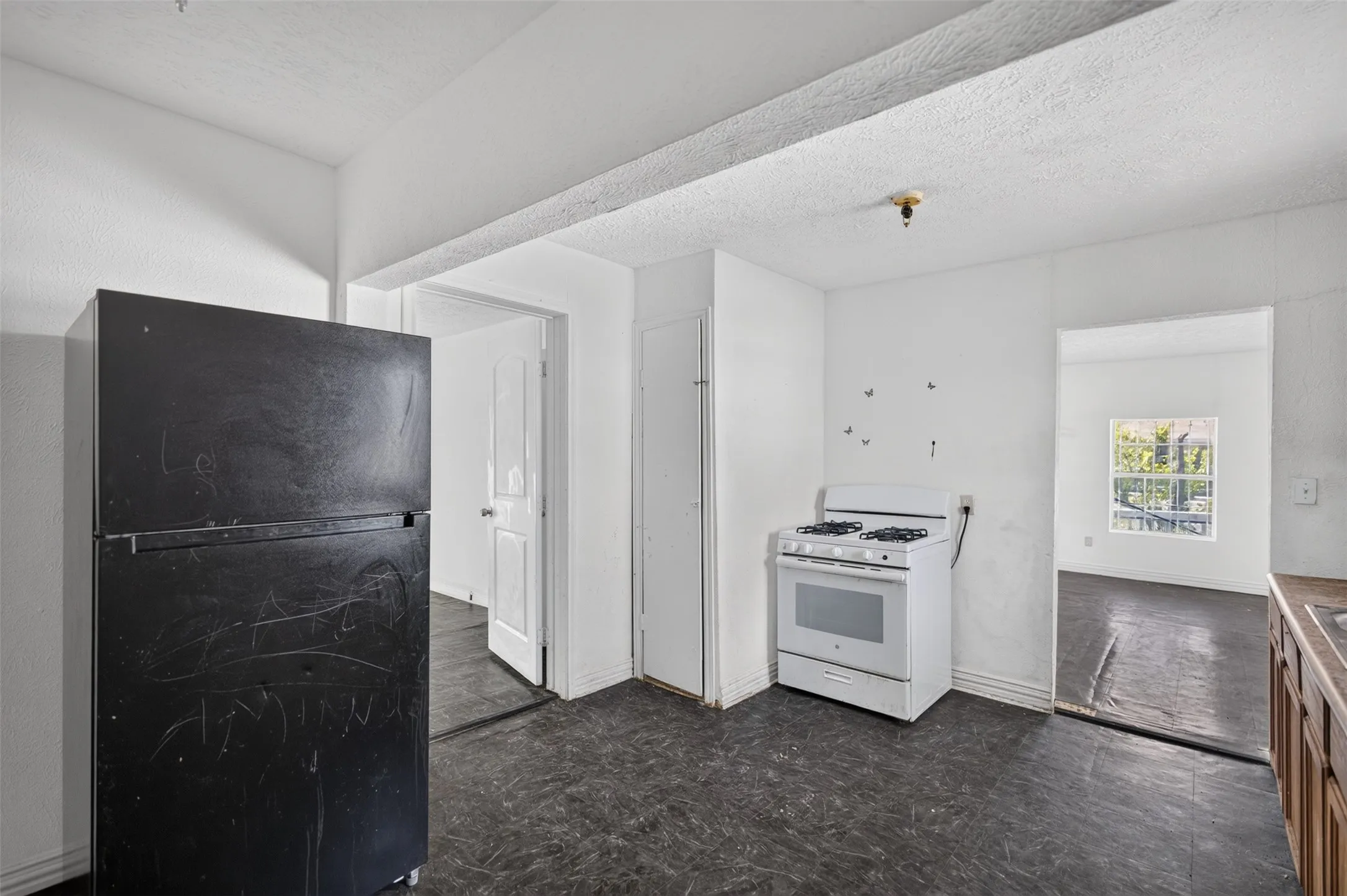 Kitchen featuring a gas range, wood-finish cabinetry, and dark-toned flooring