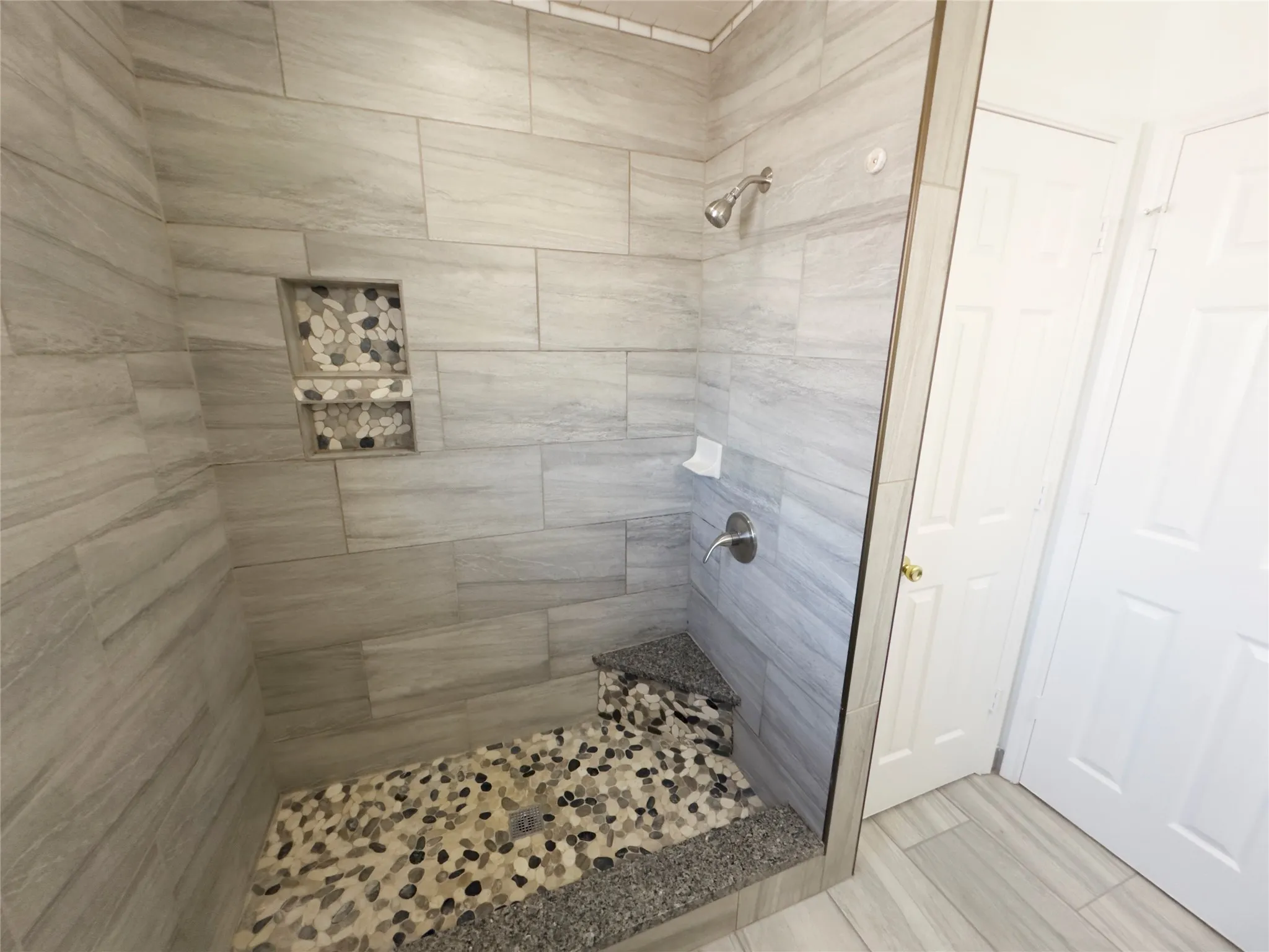 Bathroom with a stall shower and wood tiled floors