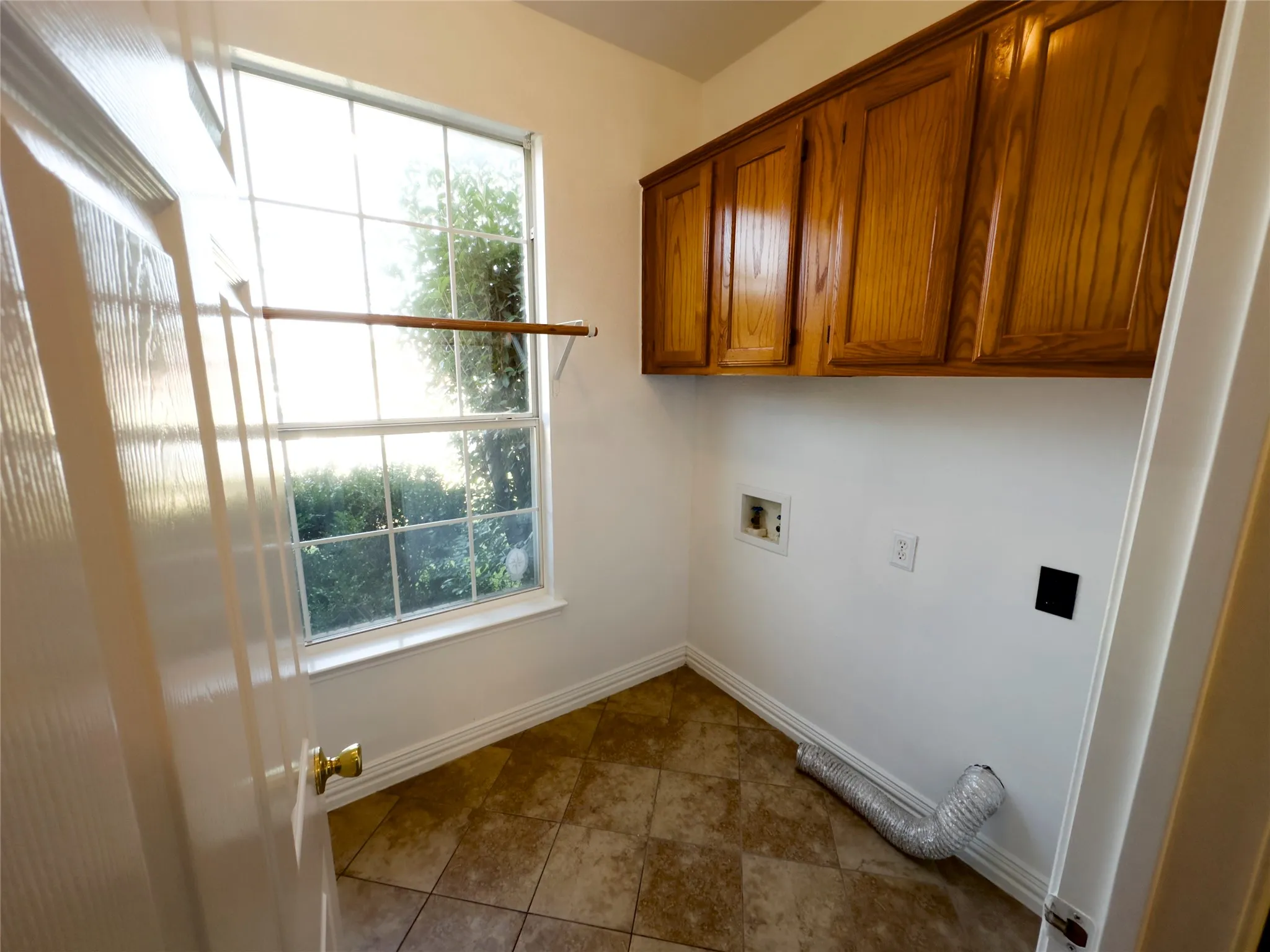 Laundry area with cabinet space and washer hookup