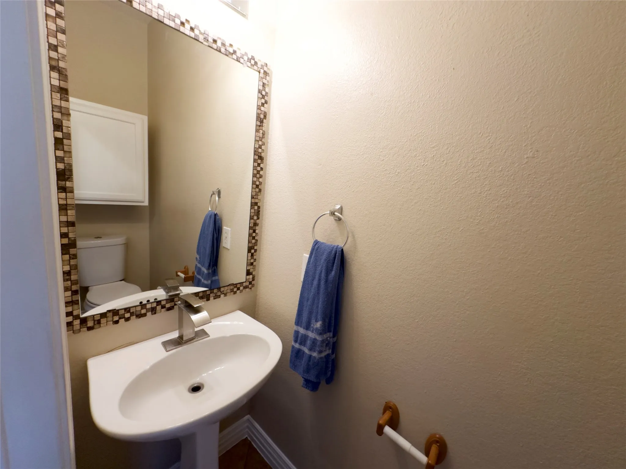 Half bathroom with toilet and a sink