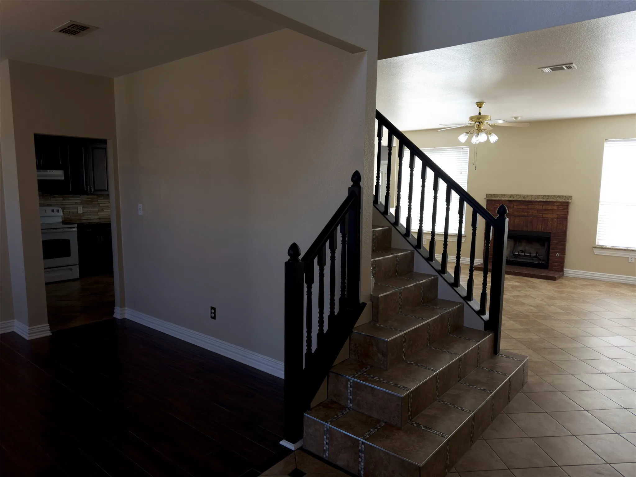 Stairway featuring plenty of natural light and a brick fireplace