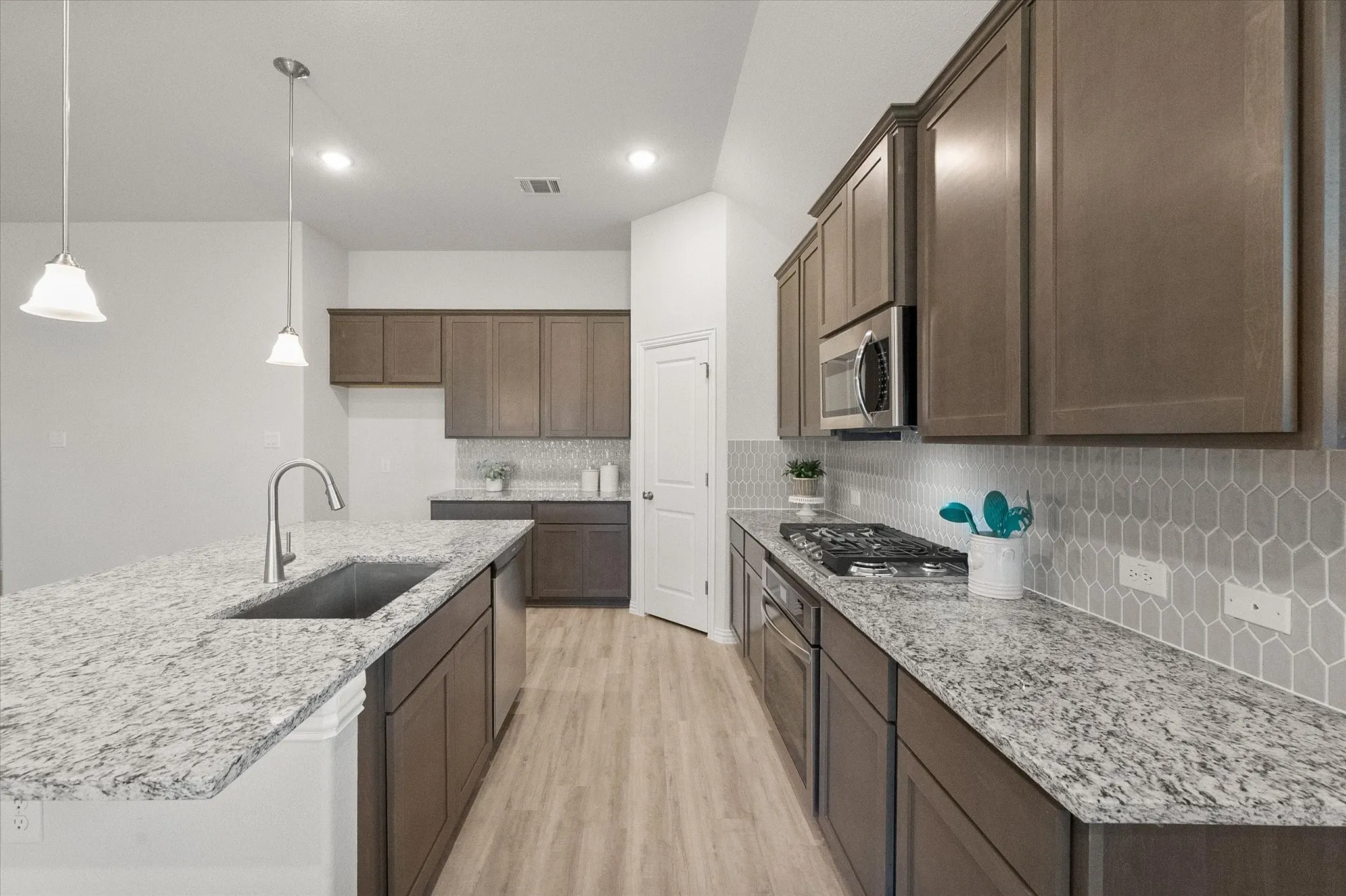 Gorgeous kitchen with granite countertops, gas cooktop, walk-in pantry and oversized island