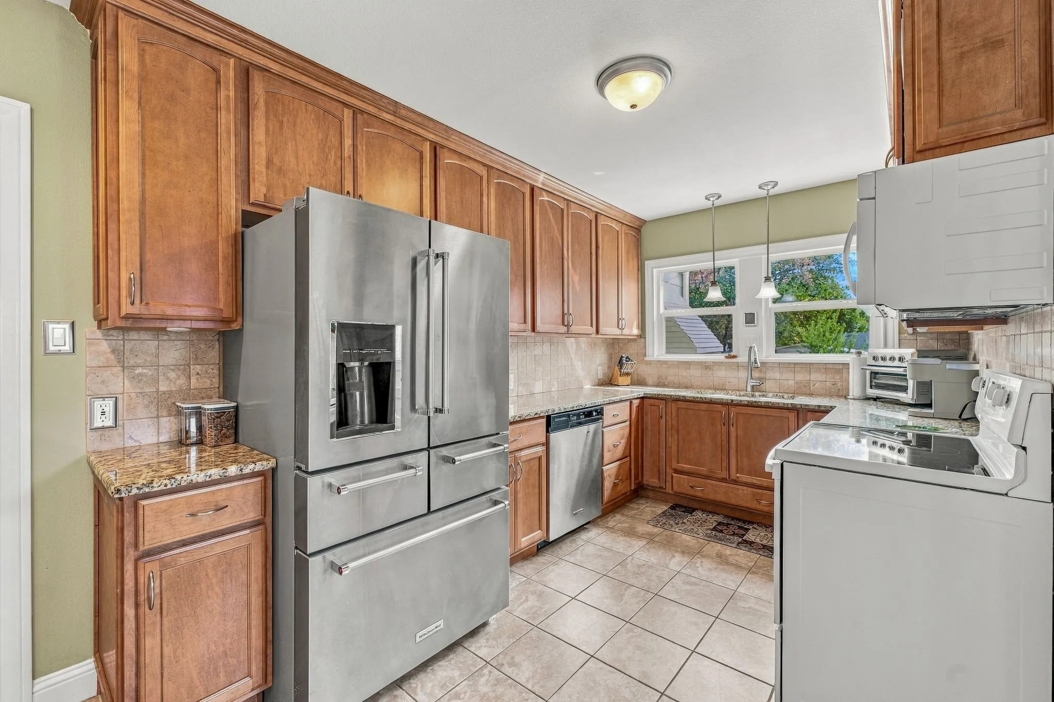 Updated kitchen with granite countertops, tile backsplash and laundry closet.