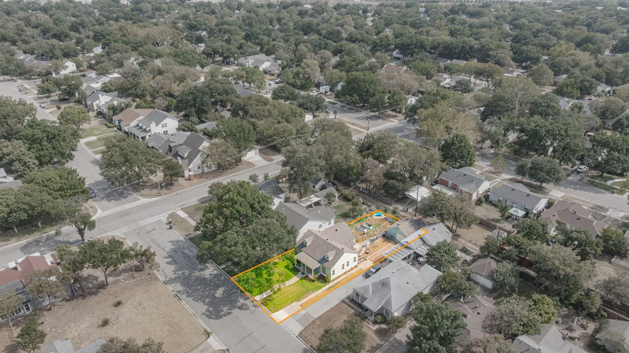 Aerial view of home with estimated property lines.