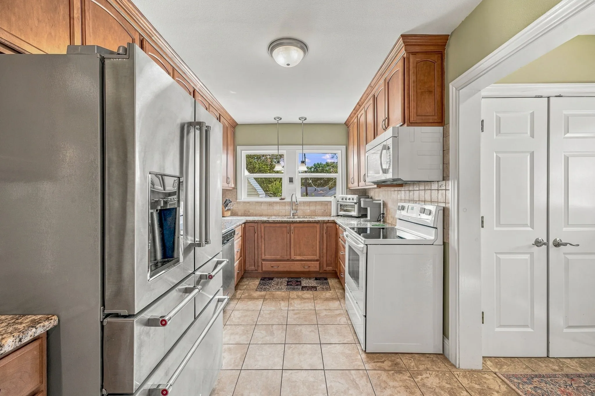 Updated kitchen with custom cabinets and large pantry.