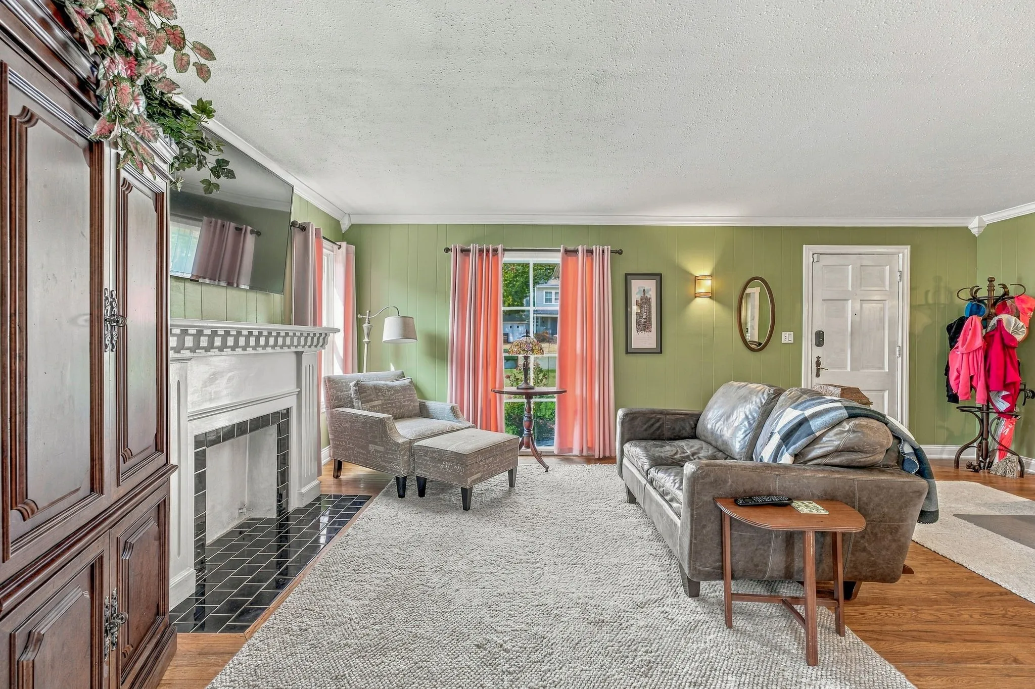 Light filled living room with original hardwood flooring.