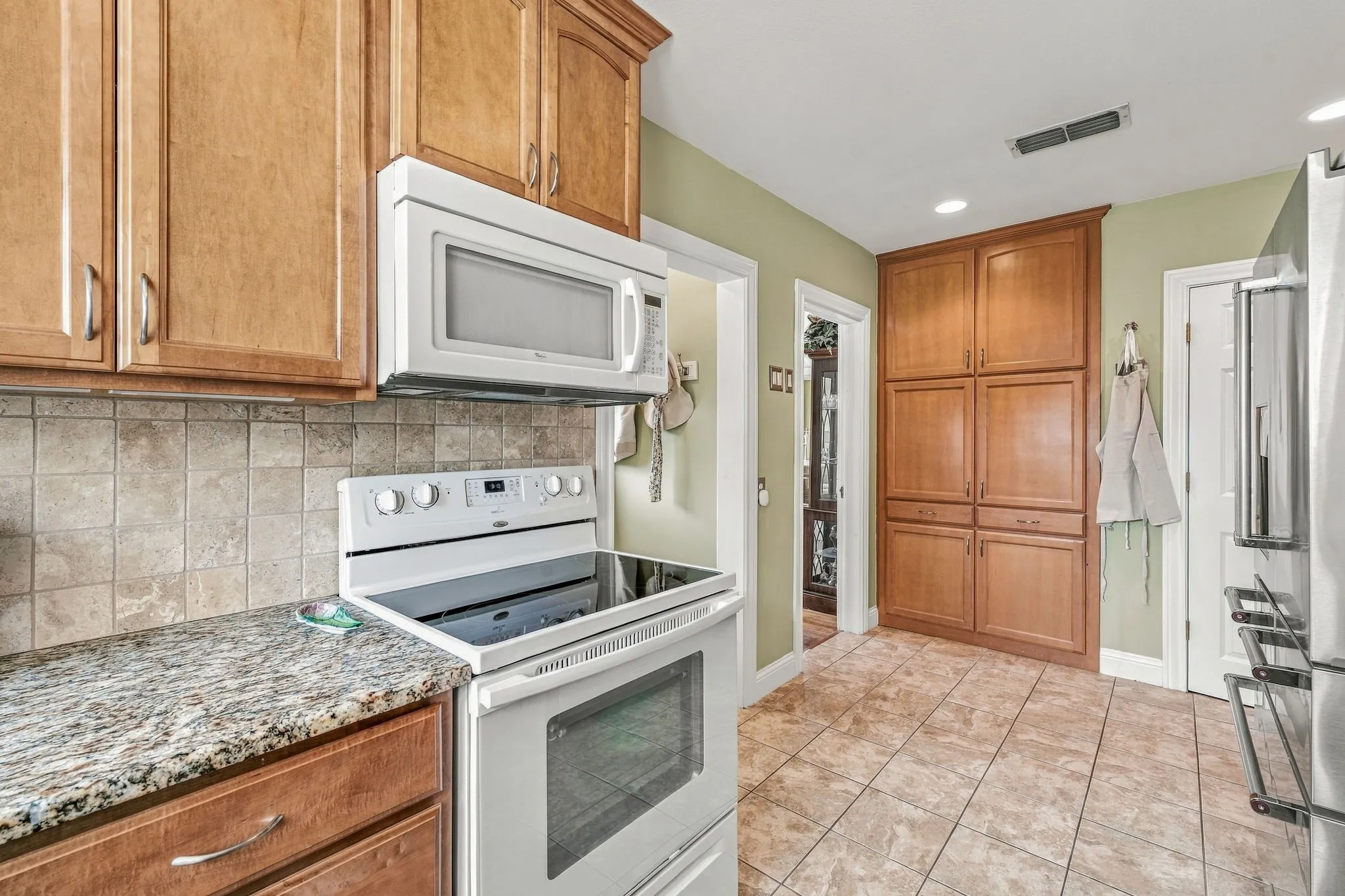 Updated kitchen with custom cabinetry and ample storage.