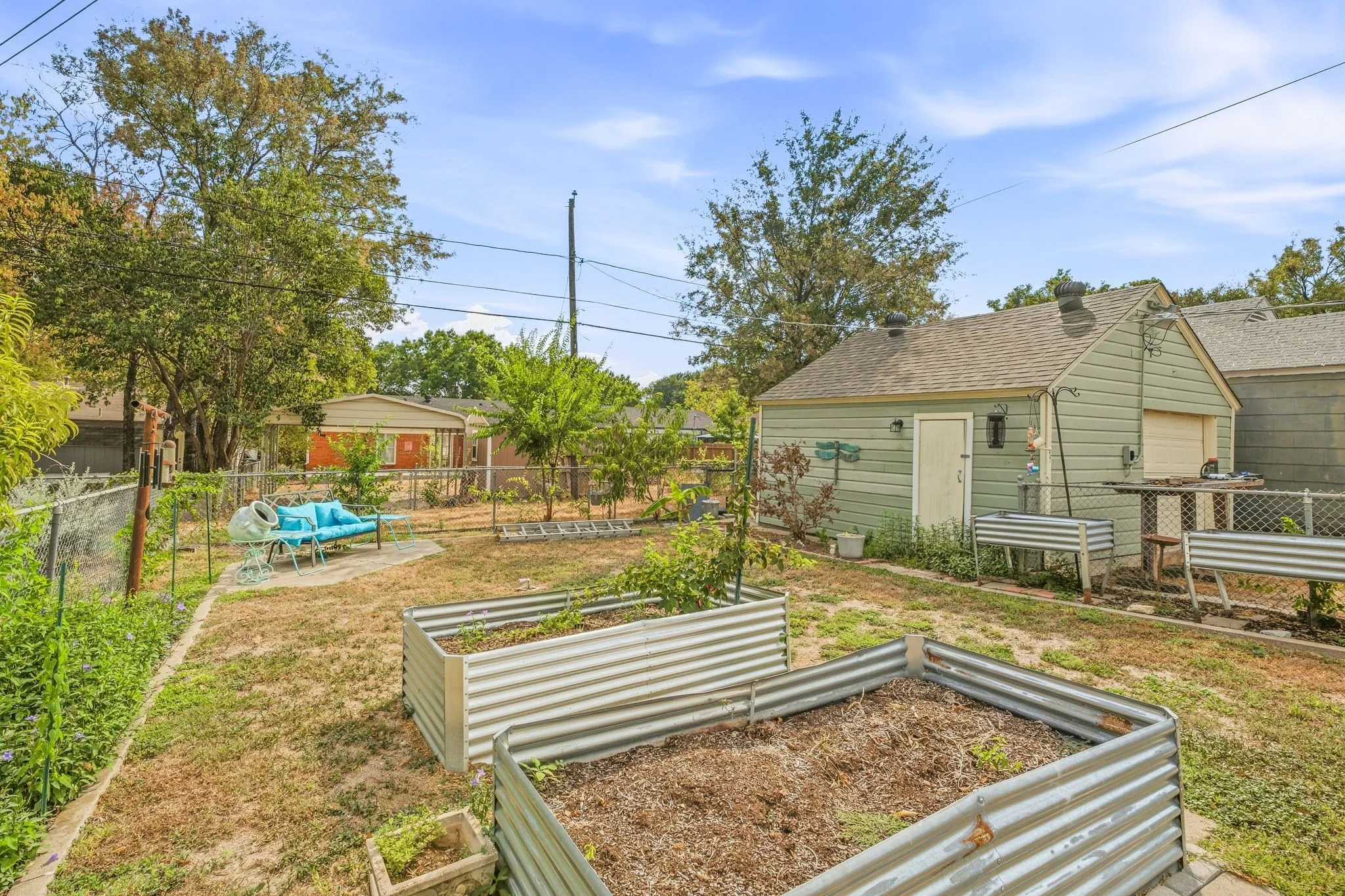 Backyard with multiple raised garden beds.