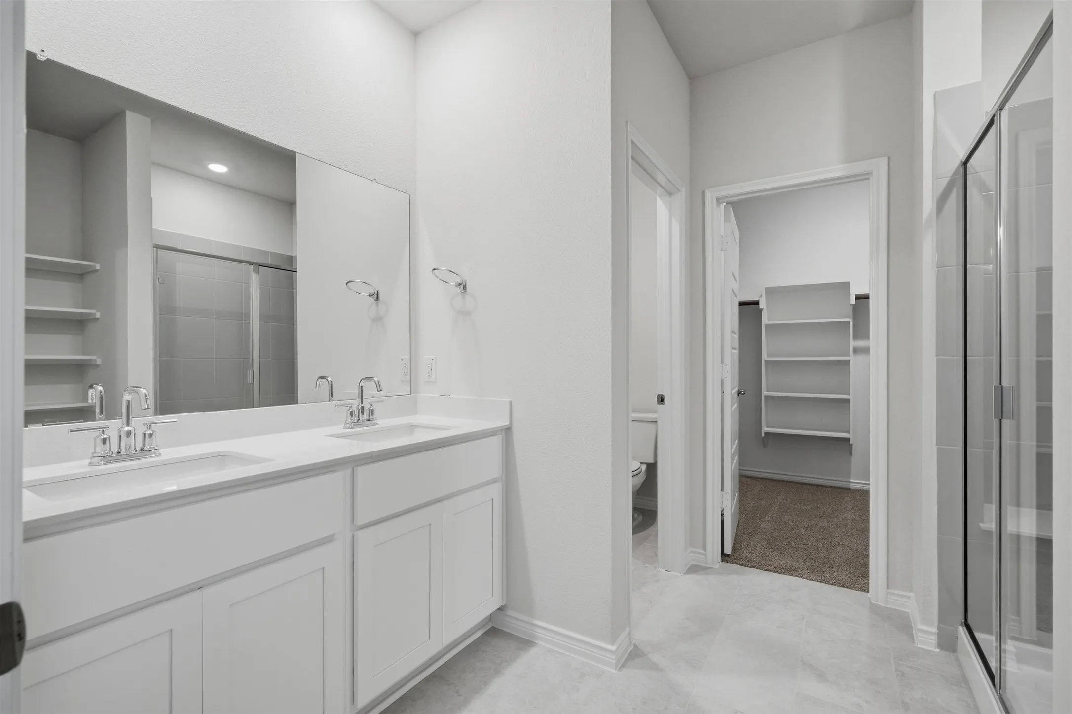 Dual vanity with undermount sinks, chrome fixtures, and a large mirror