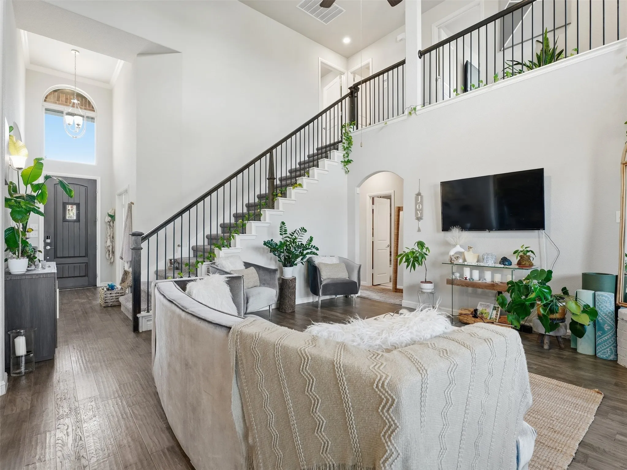 Two-story foyer with an arched transom window and chandelier