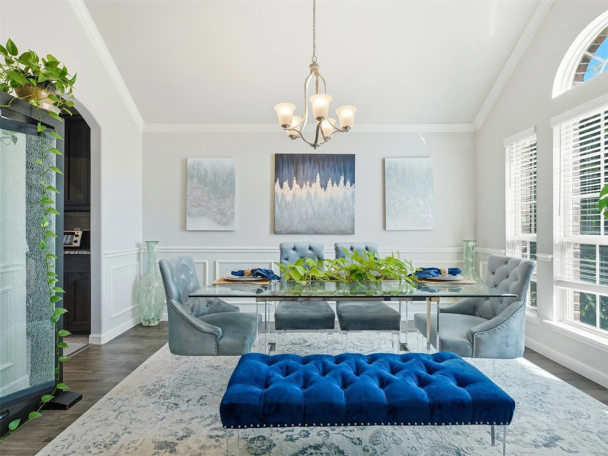 Formal dining space featuring a vaulted ceiling and wood-finish flooring