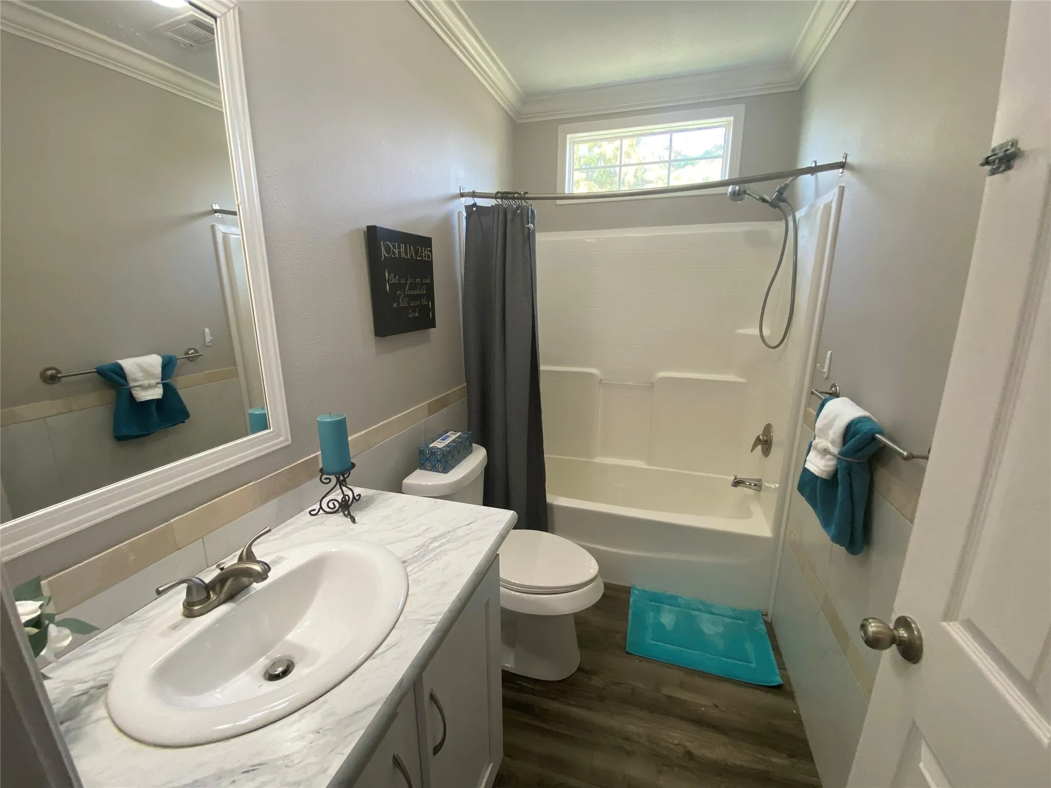 Bathroom with crown molding, shower / tub combo with curtain, vanity, and dark wood-style flooring
